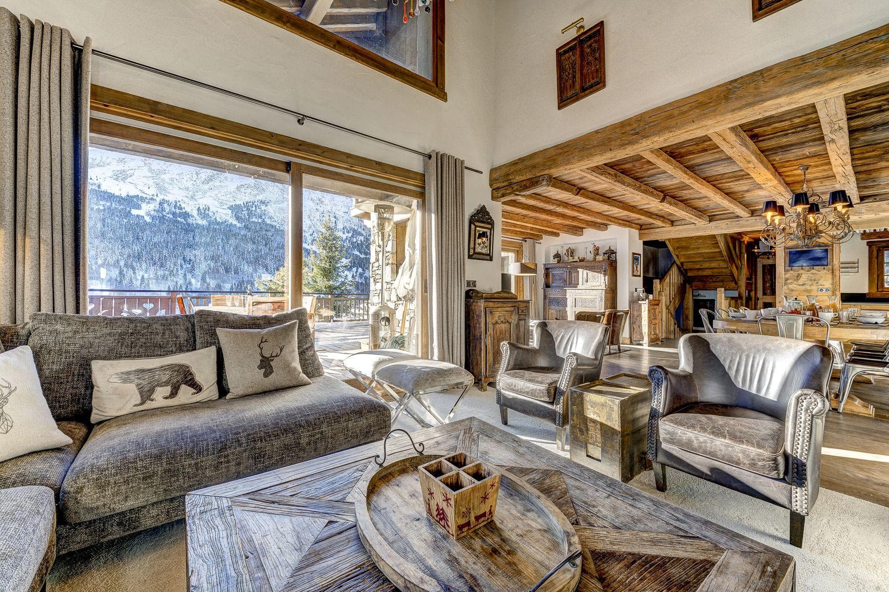 Open-plan living area with mountain views and direct terrace access