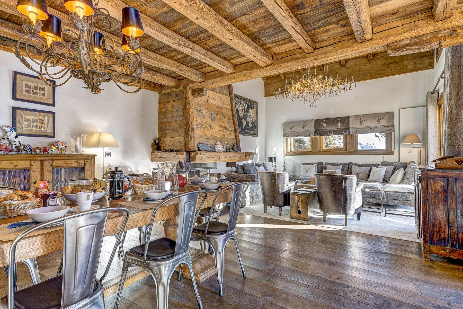 Open-plan dining and living area with wood-burning fireplace and exposed beams