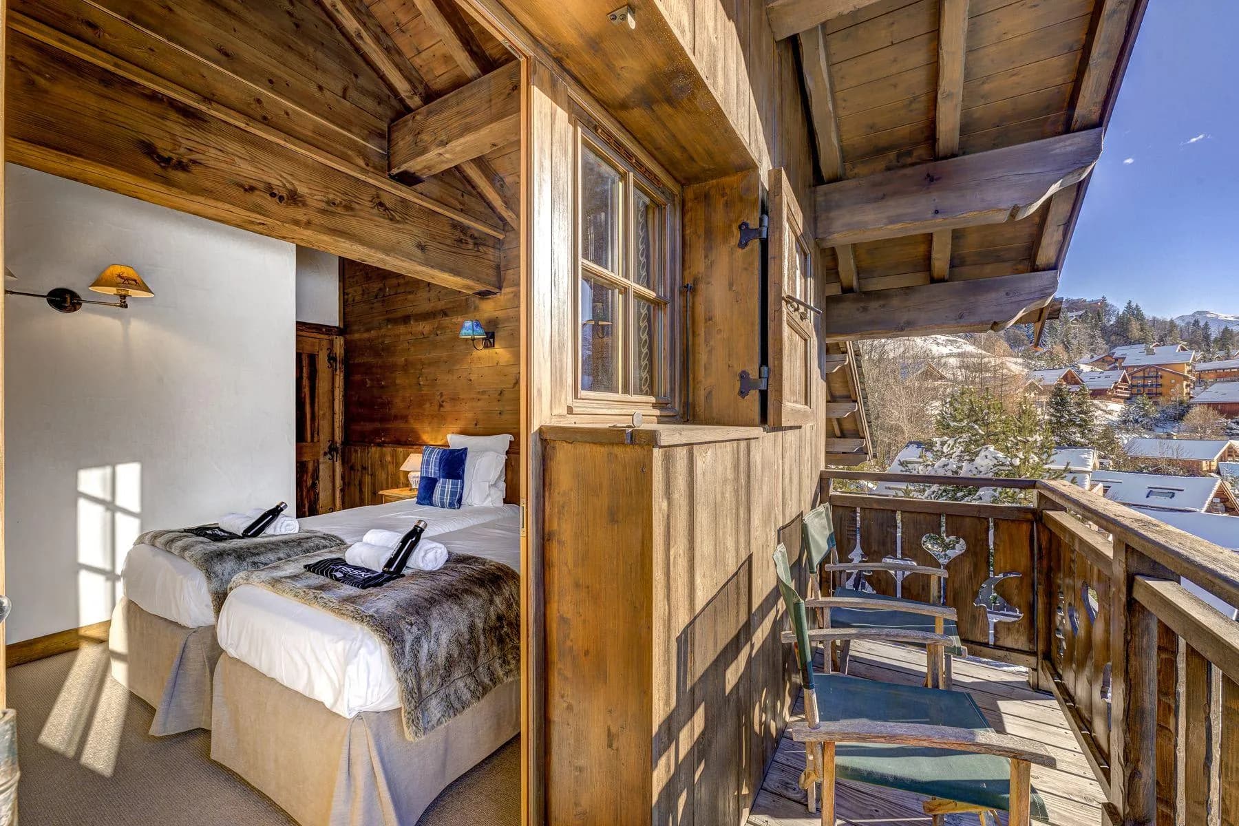Guest bedroom with twin beds and private balcony access