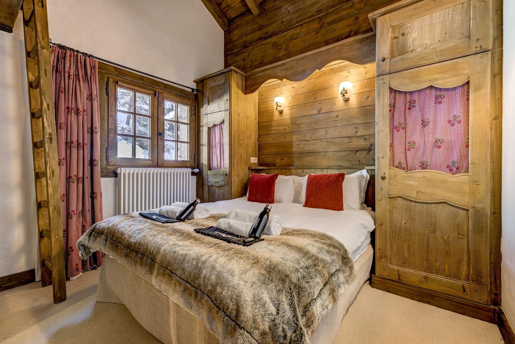 Guest bedroom with double bed and integrated wood storage wardrobes