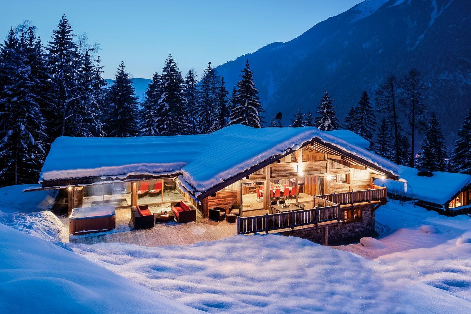 Ski chalet exterior with heated deck, hot tub, and mountain views