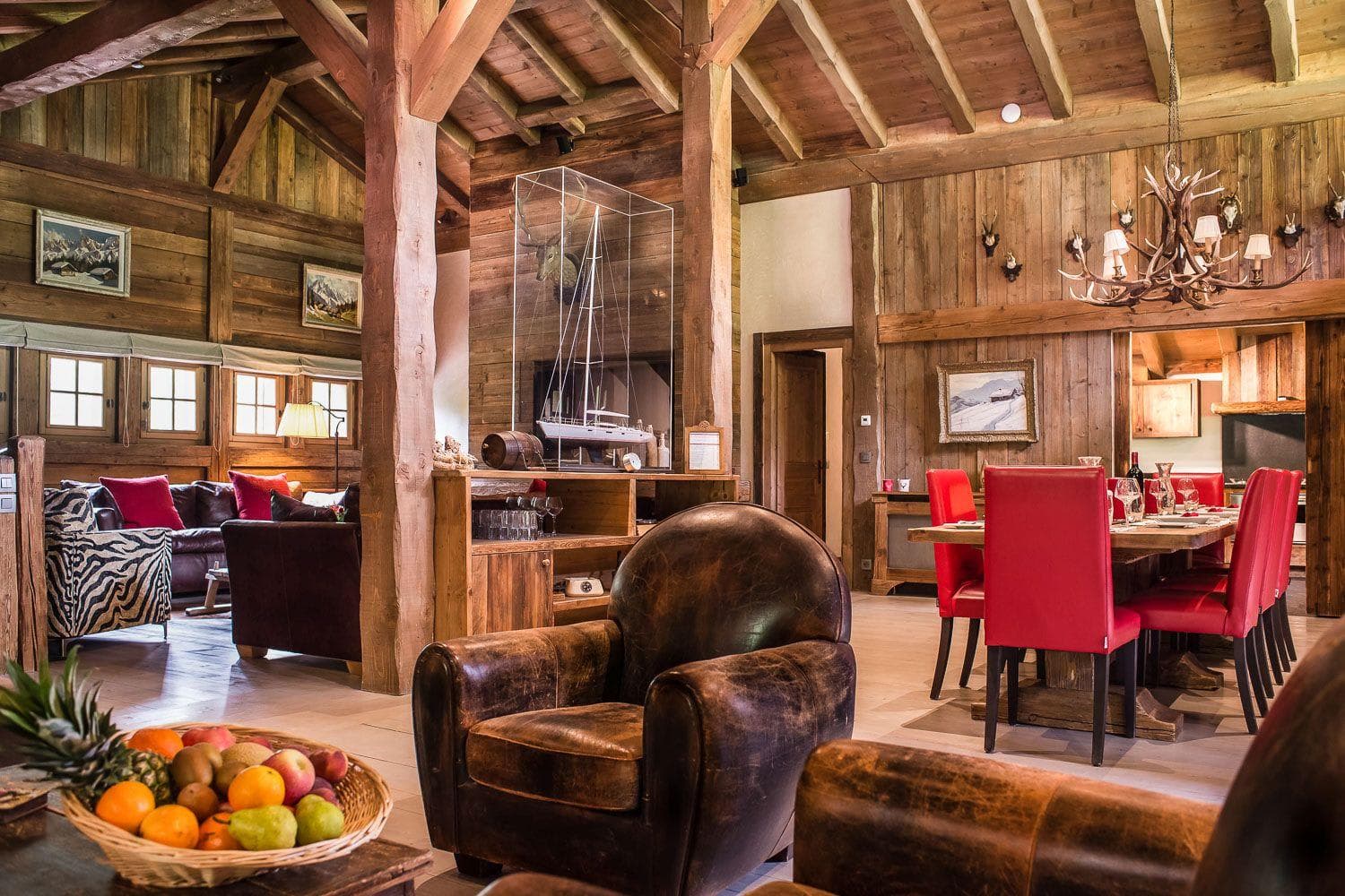 Open living area with vaulted timber ceilings and dining seating for 8