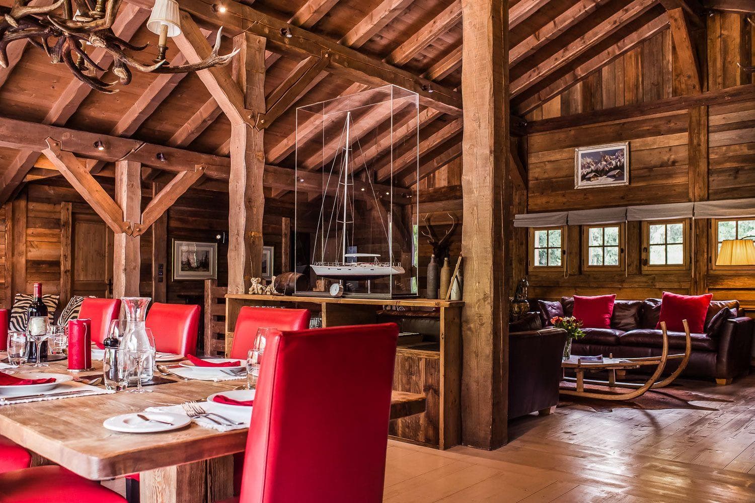 Open-plan dining and living area with vaulted timber ceilings and exposed beams
