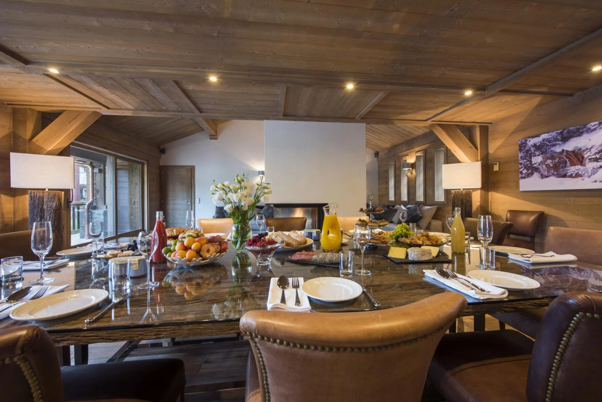 Dining area seating 10 with glass-top table and fireplace