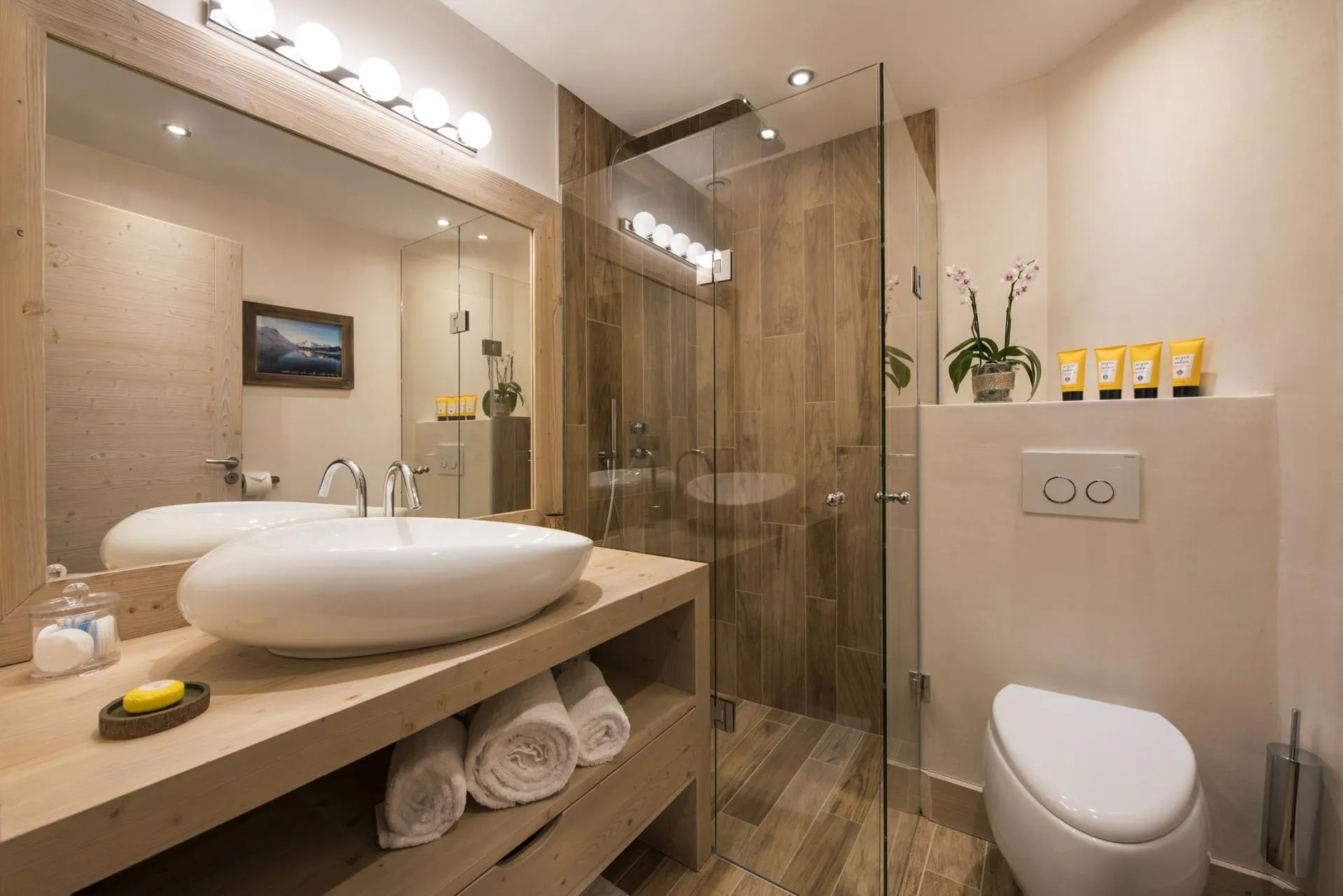 Bathroom with walk-in glass shower and vessel sink vanity
