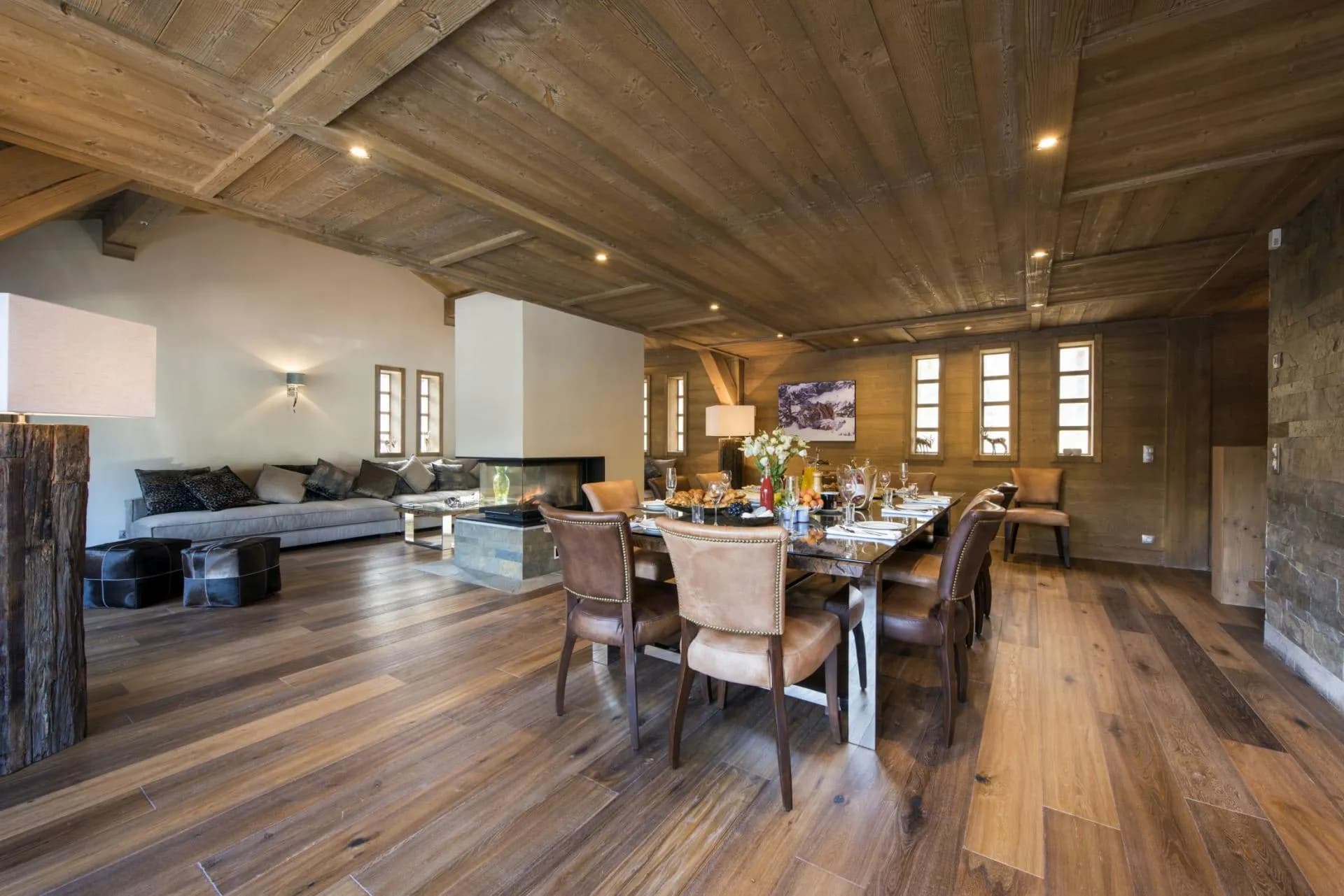 Open-plan dining area with 10-person table and wood-burning glass fireplace