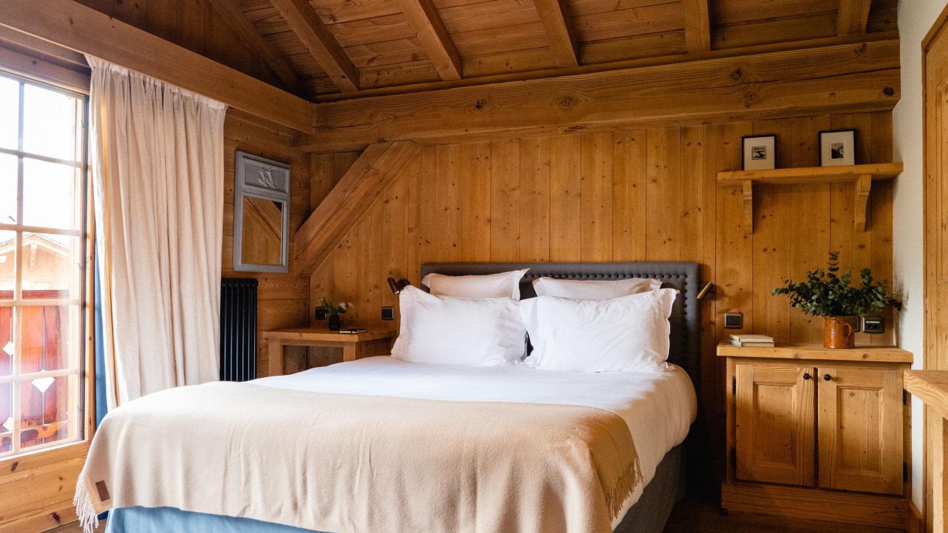 King bedroom featuring exposed timber beams and balcony access
