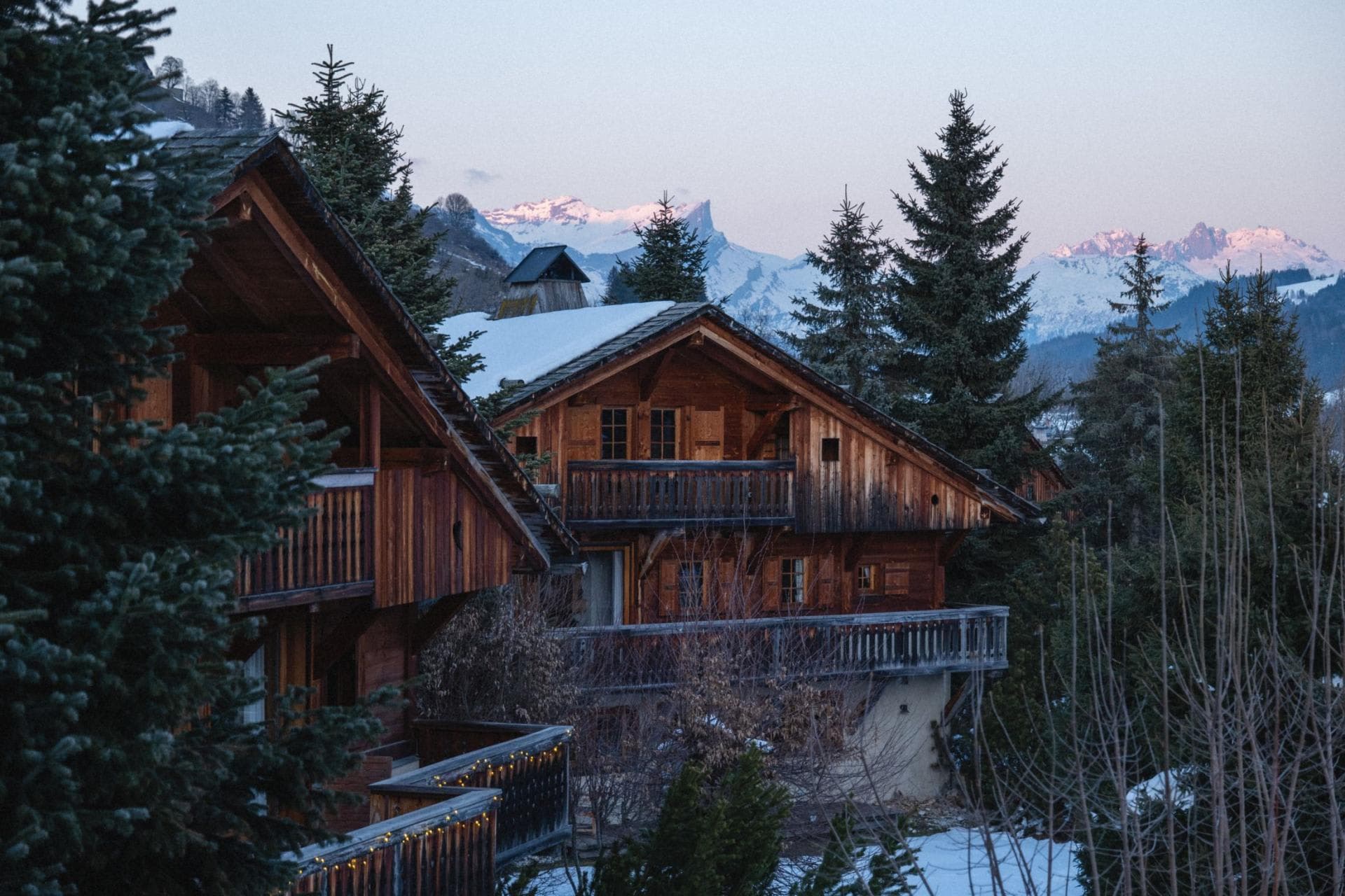 Timber chalets with private balconies and snow-capped mountain views