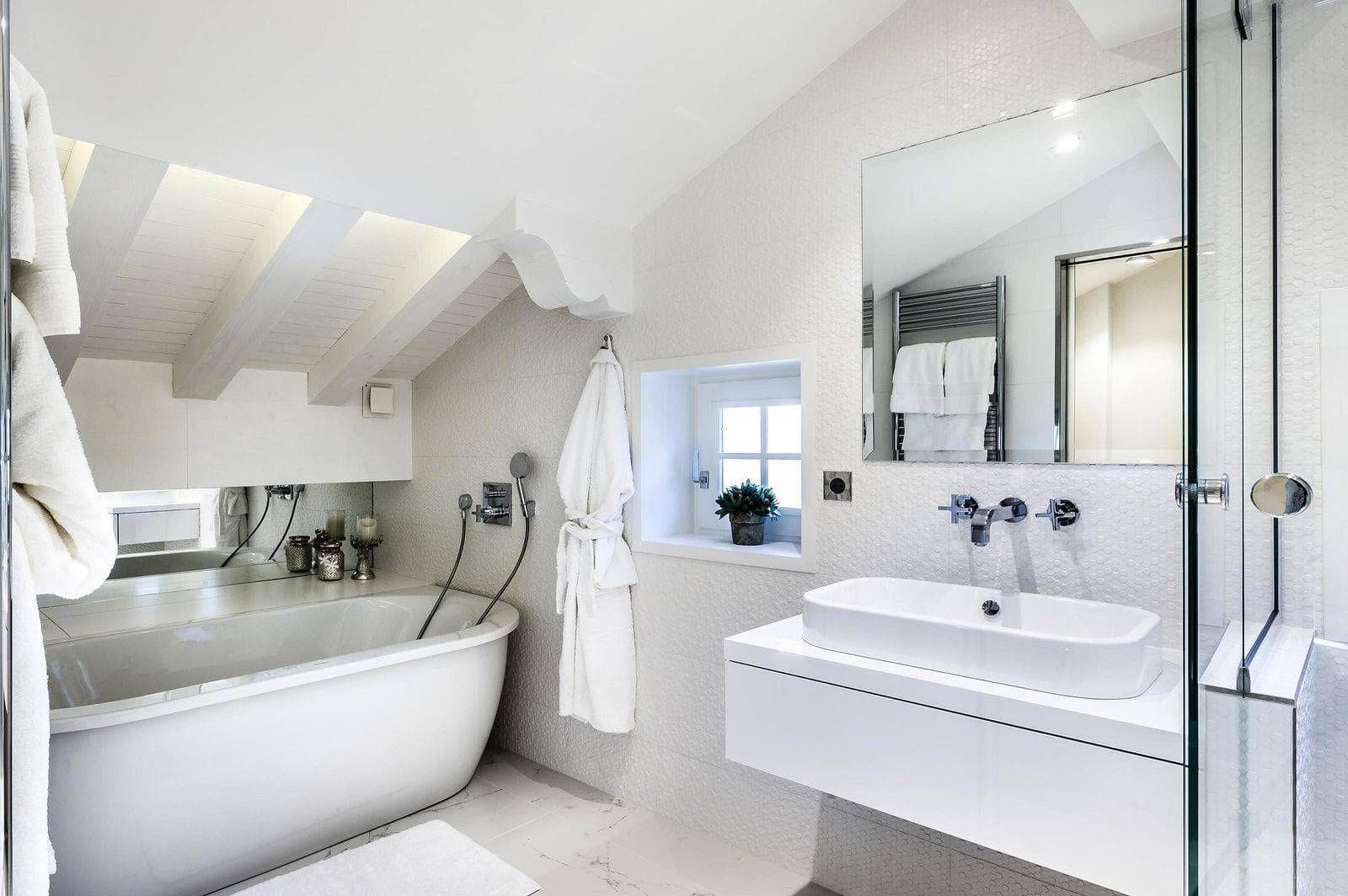 Bathroom with soaking tub, walk-in shower, and heated towel rack
