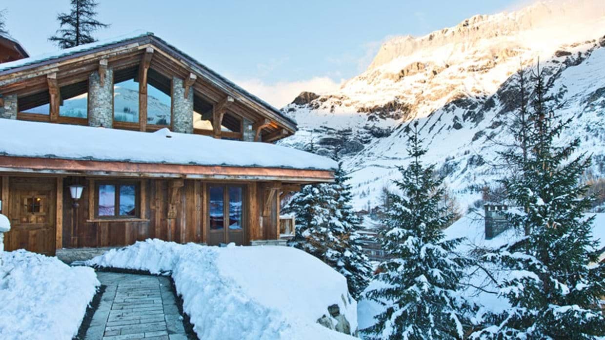Ski-in chalet exterior with heated stone walkway and mountain views