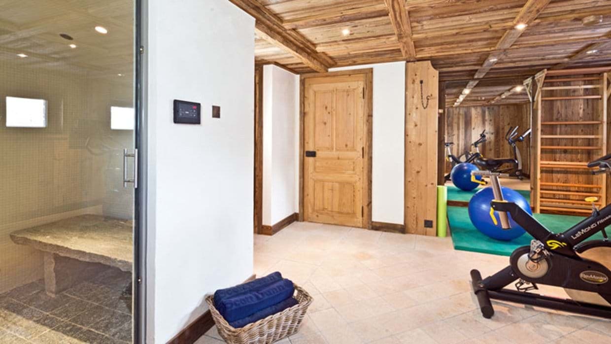 Private wellness area with steam room and gym equipment