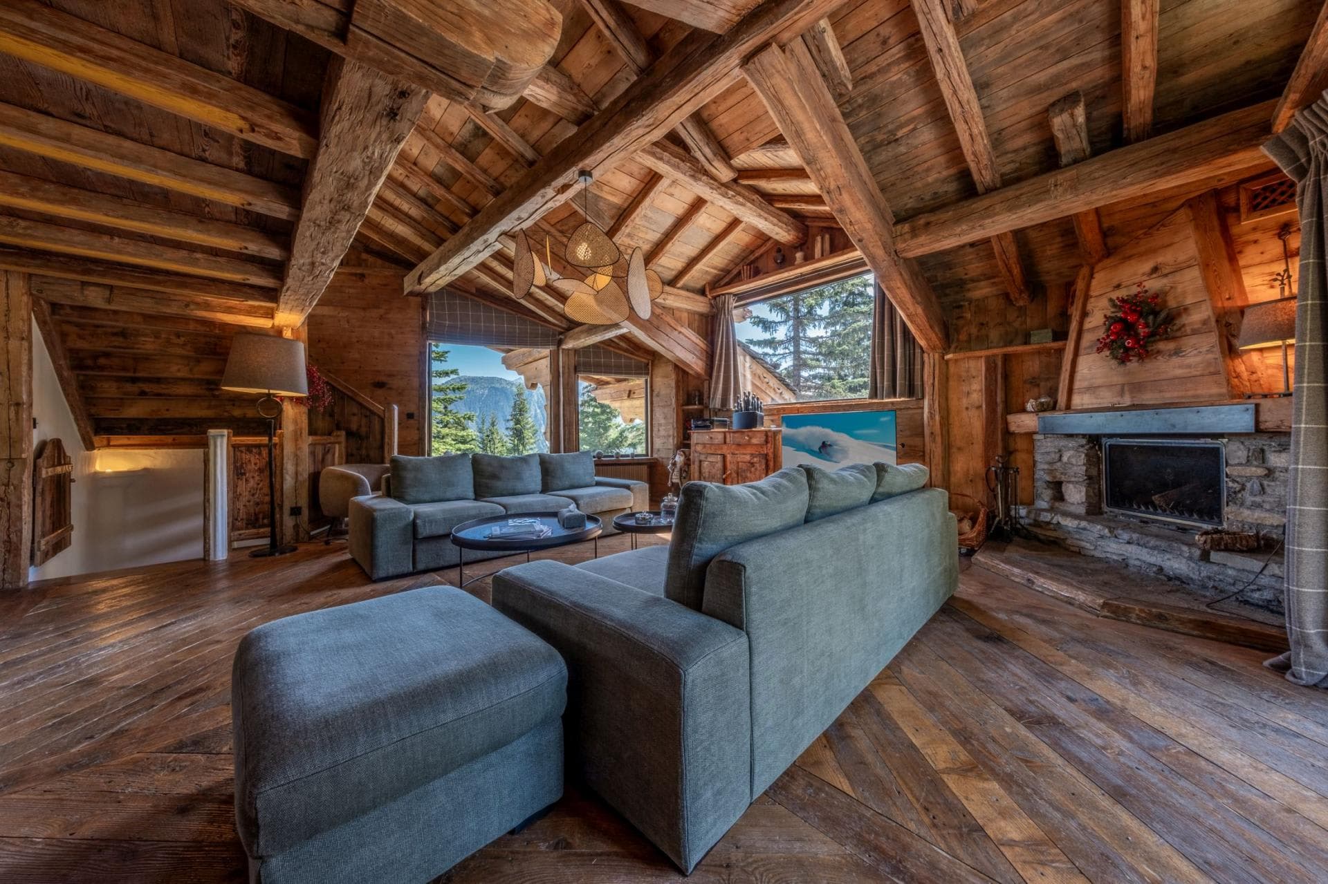 Living area with stone fireplace and reclaimed wood vaulted ceilings