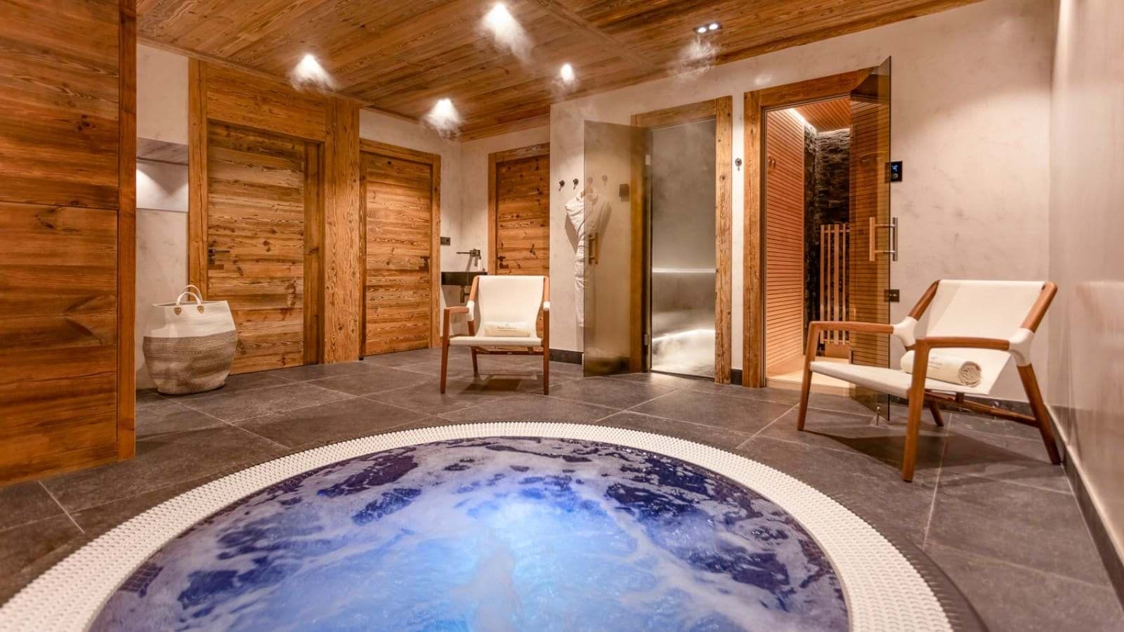Spa area with indoor hot tub, steam room, and sauna