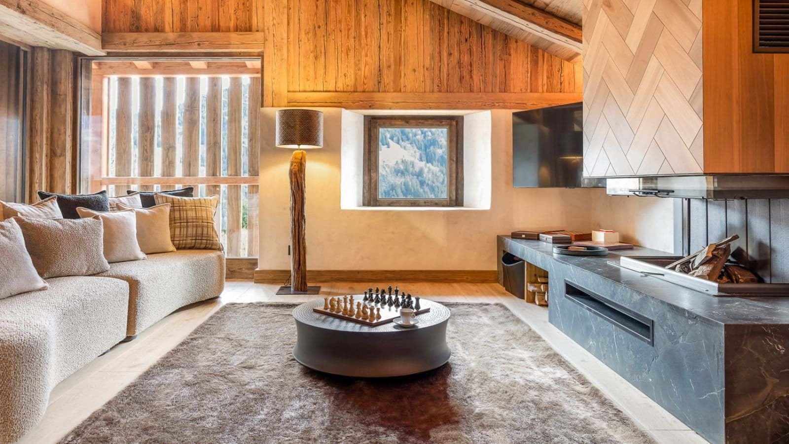 Living area with wood-burning fireplace and mountain-view window nook