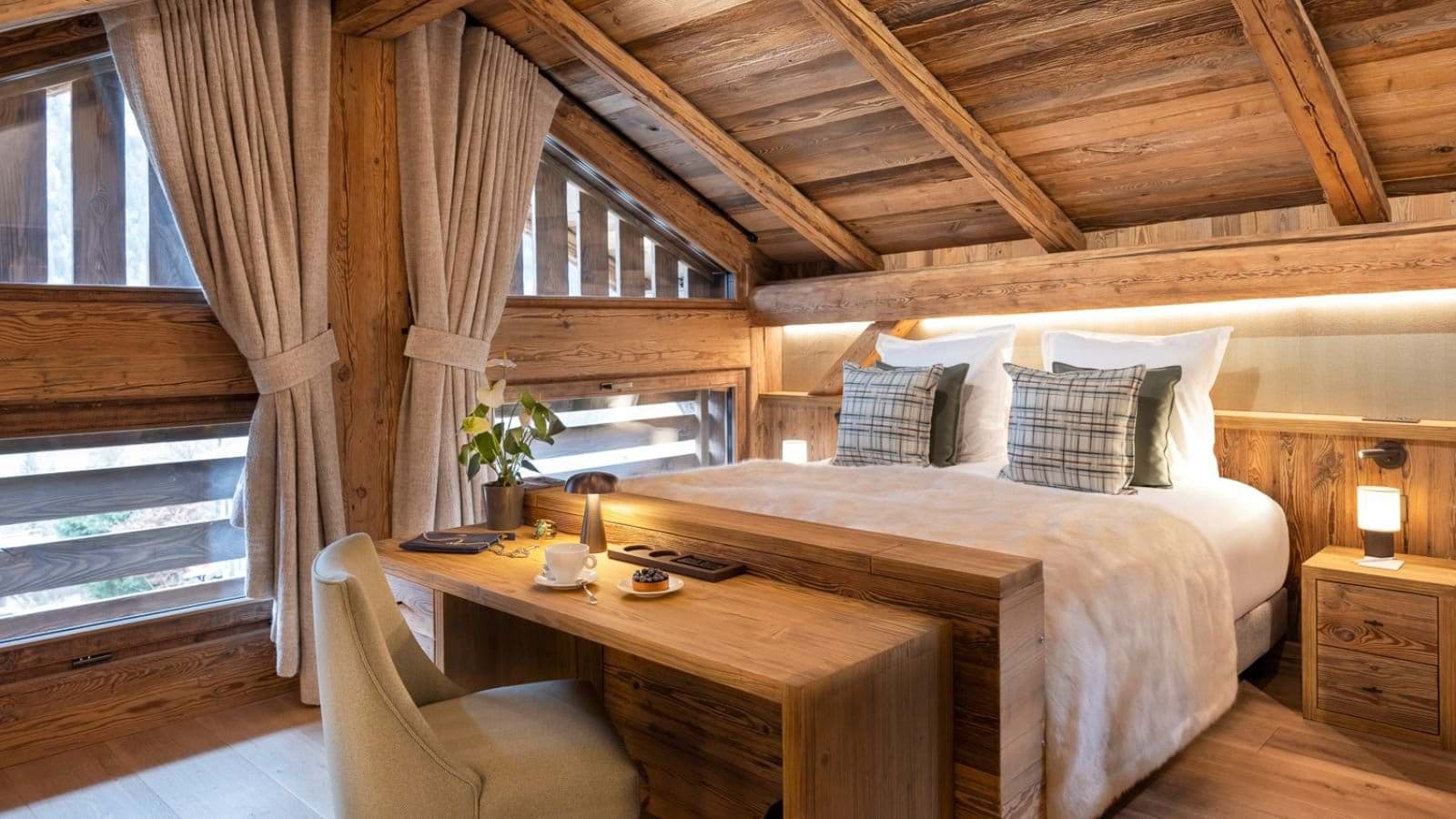 Loft bedroom with queen bed and integrated desk; timber-clad ceiling