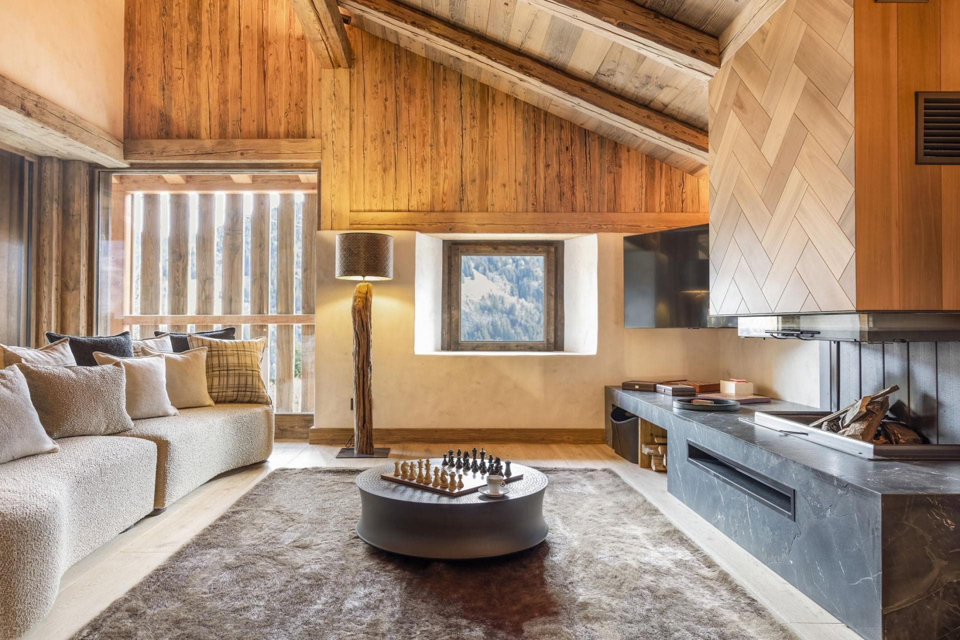 Living area with wood-burning fireplace and mountain-view window