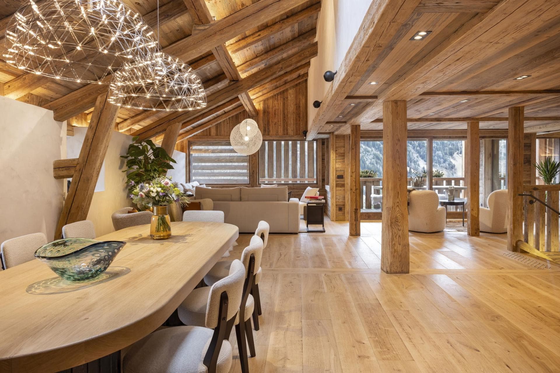 Open-plan dining area with vaulted timber ceilings and seating for 8