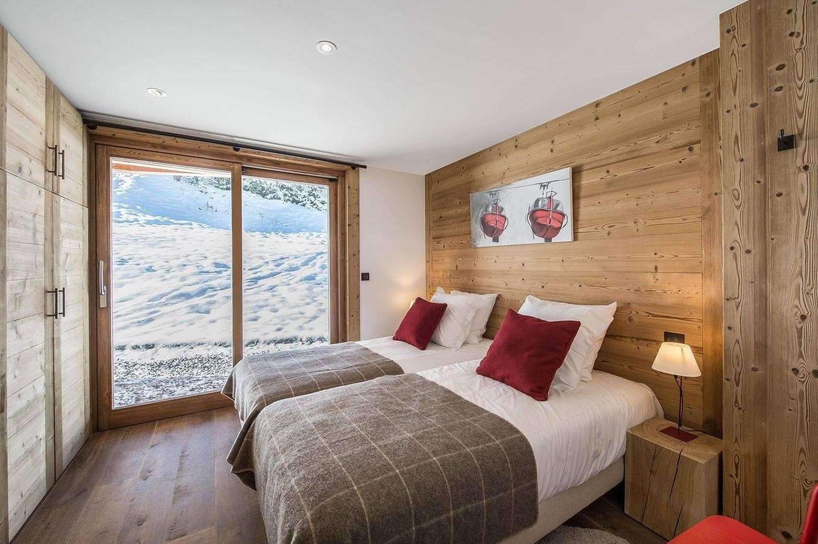 Twin bedroom with timber walls and terrace access