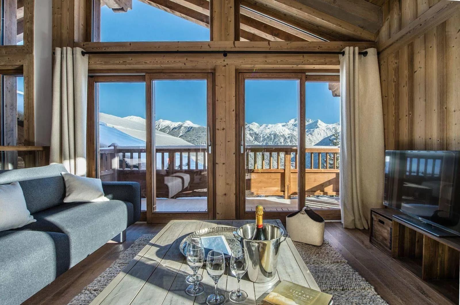 Living room with large windows and mountain-facing balcony