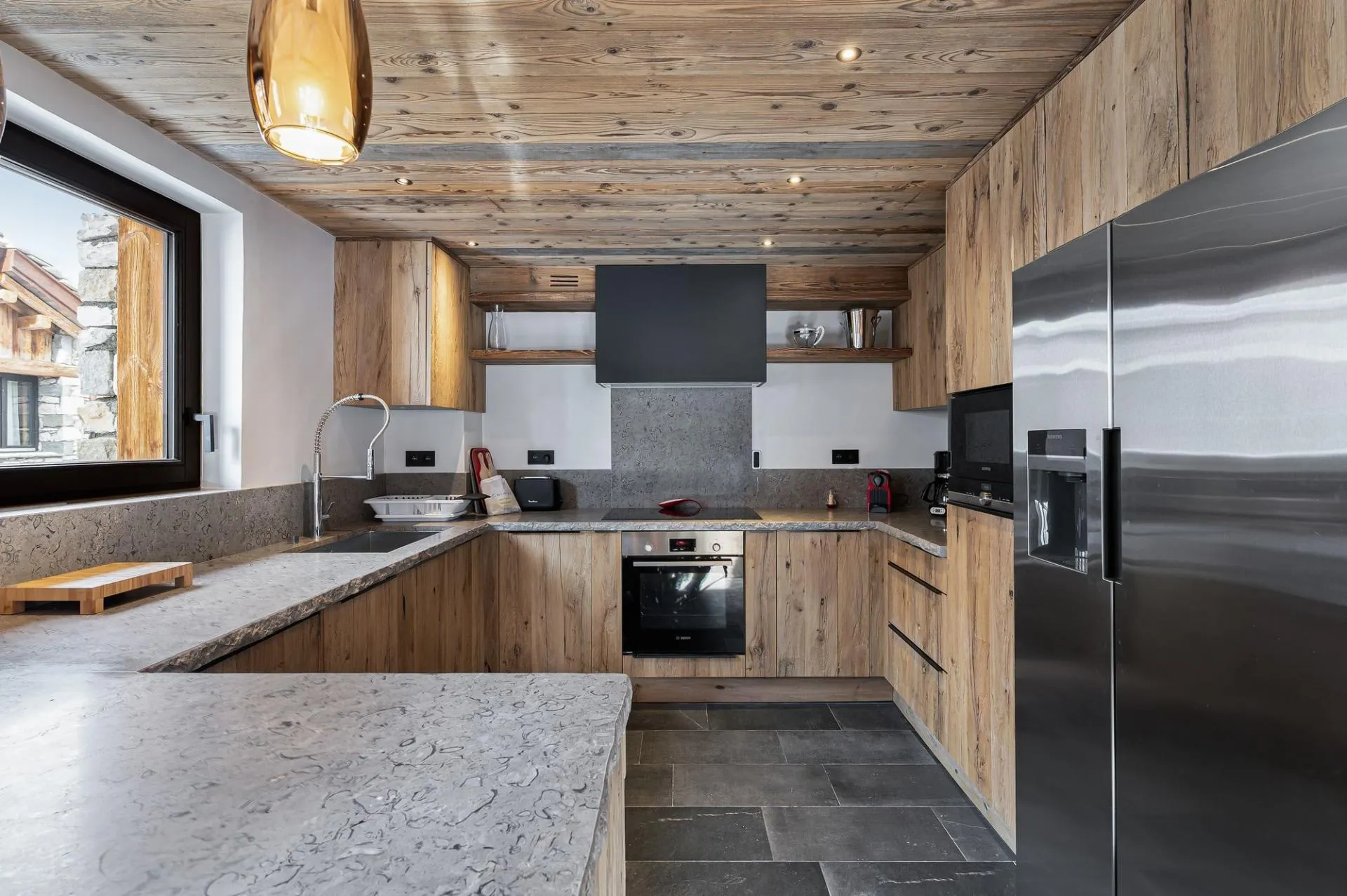 Fitted kitchen with induction hob and timber cabinetry