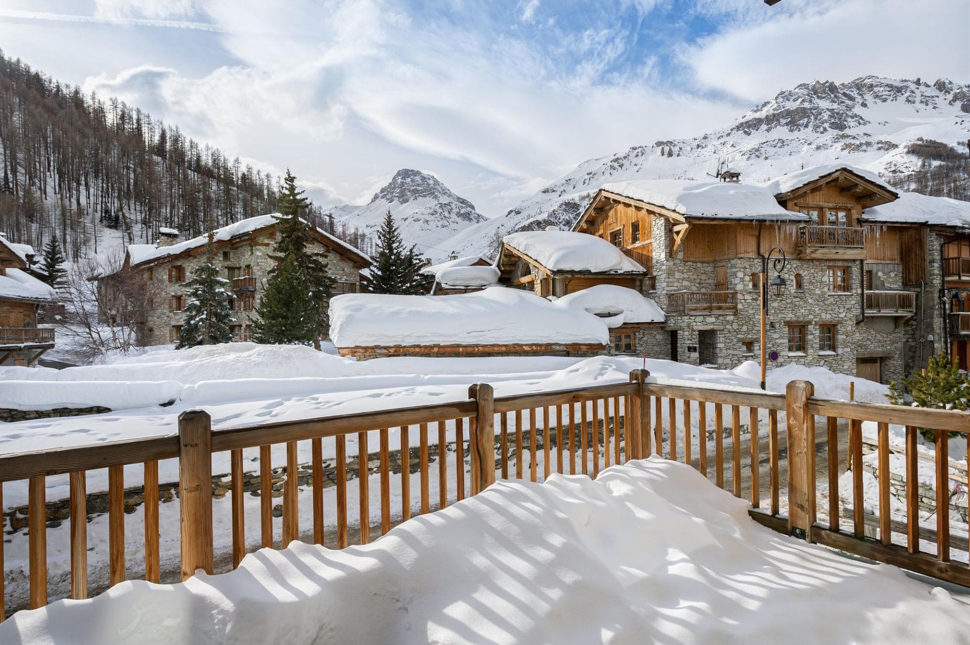 Private balcony with views of snow-covered mountains and alpine chalets