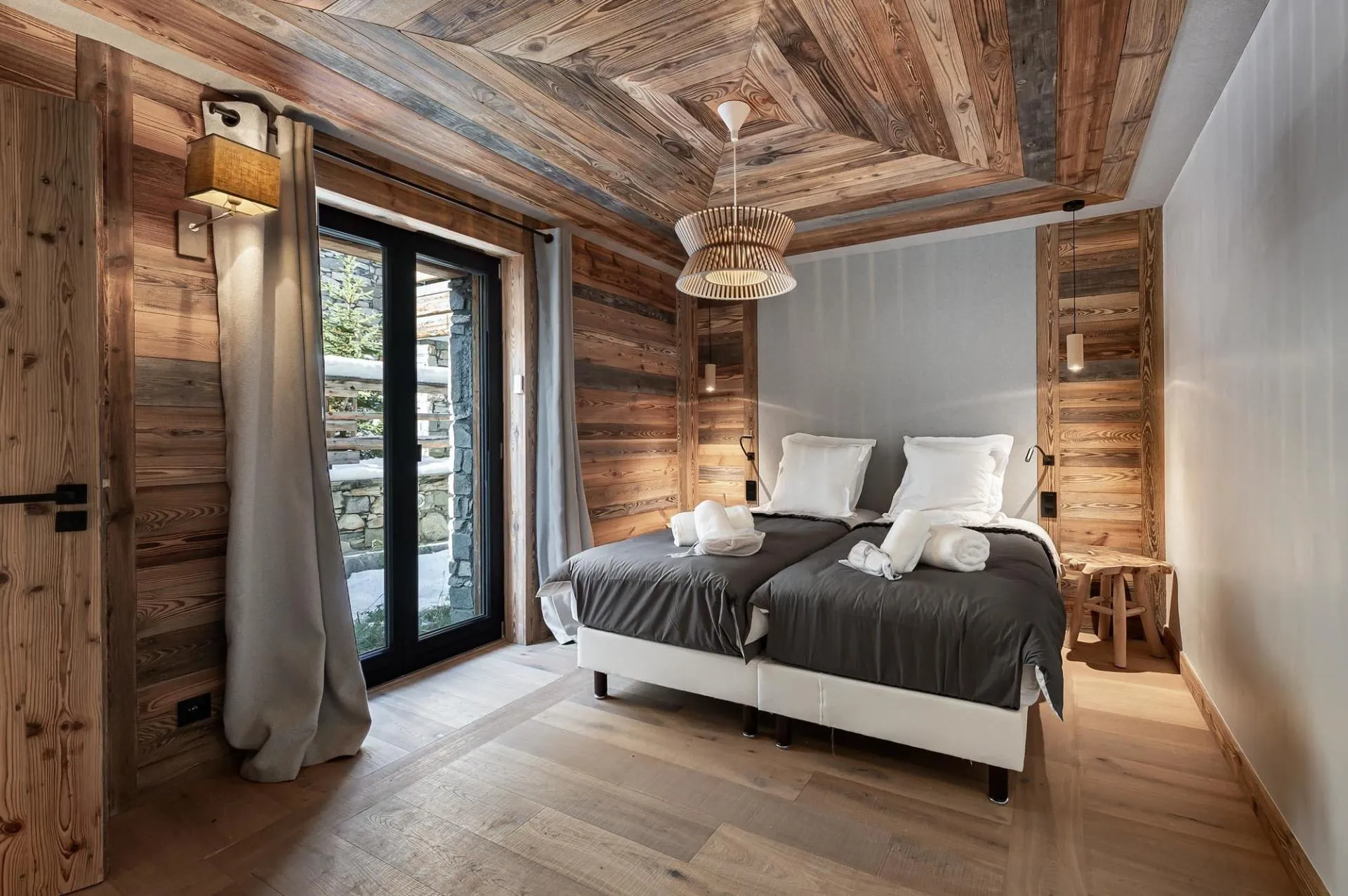 Timber-lined bedroom with glazed exterior doors