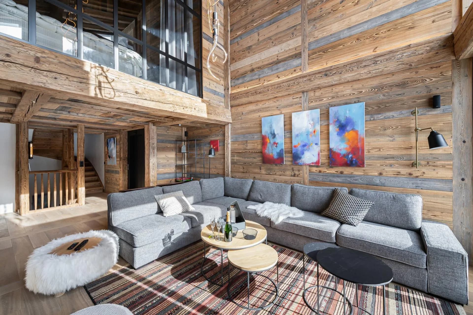 Living room with sofas below a glazed mezzanine