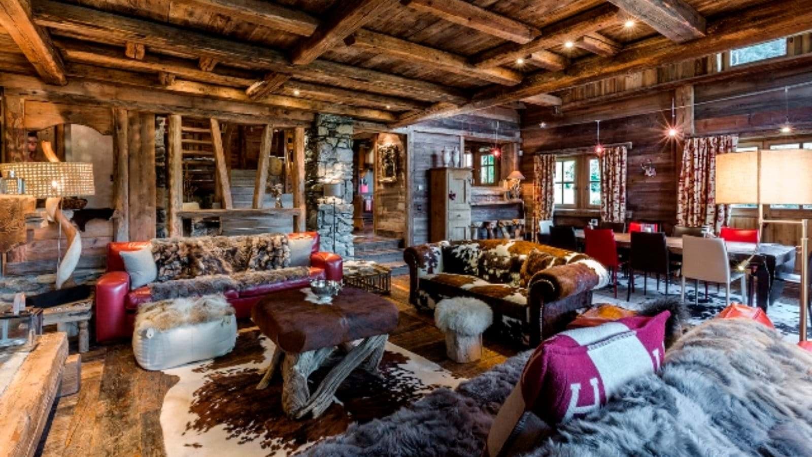Open-plan living area with reclaimed wood beams and dining seating for 8