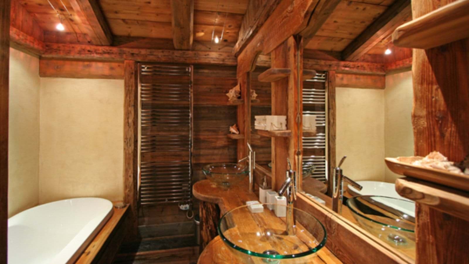Bathroom with soaking tub, glass vessel sinks, and heated towel rack