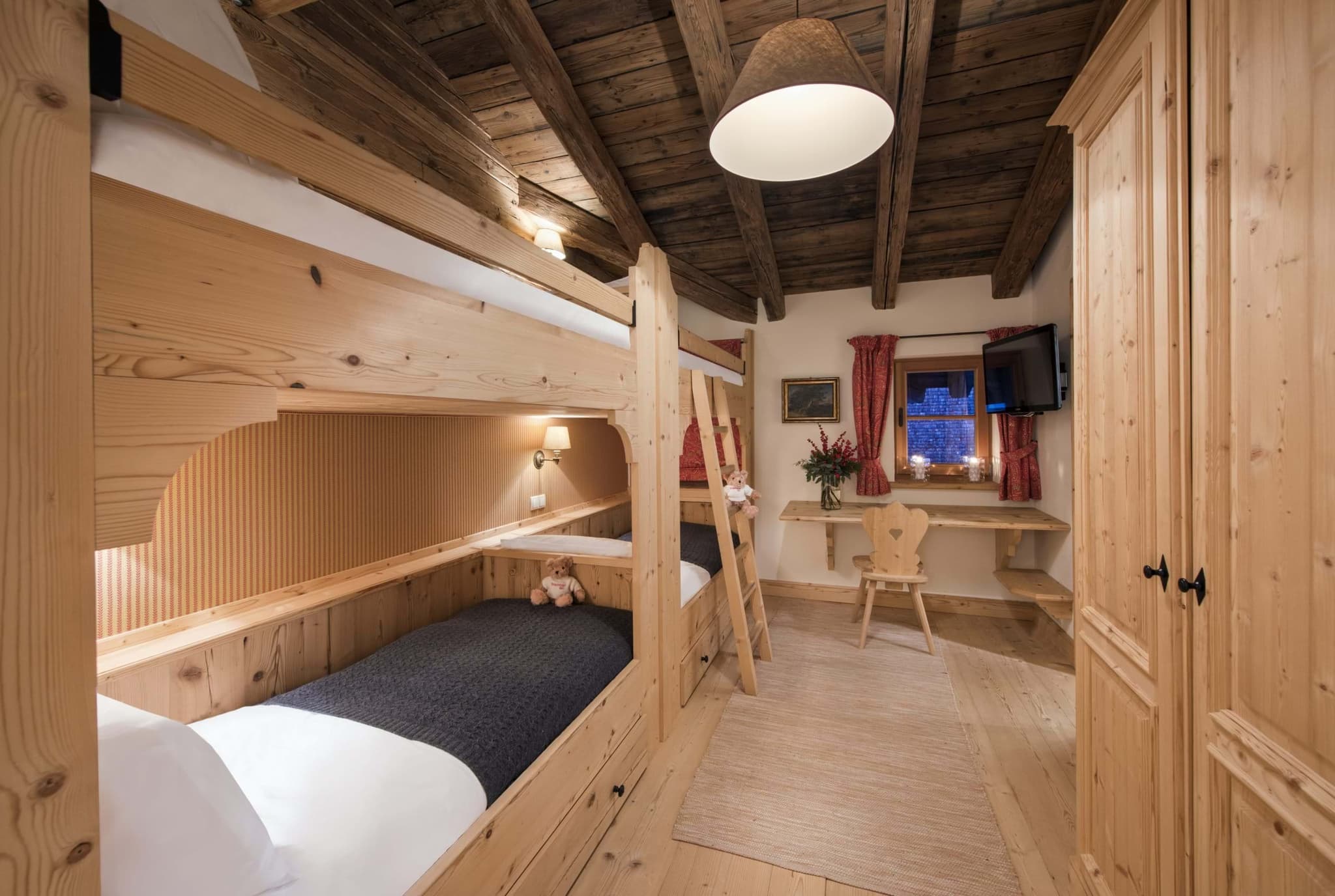 Bunk room sleeps 4; features built-in desk and wall-mounted TV