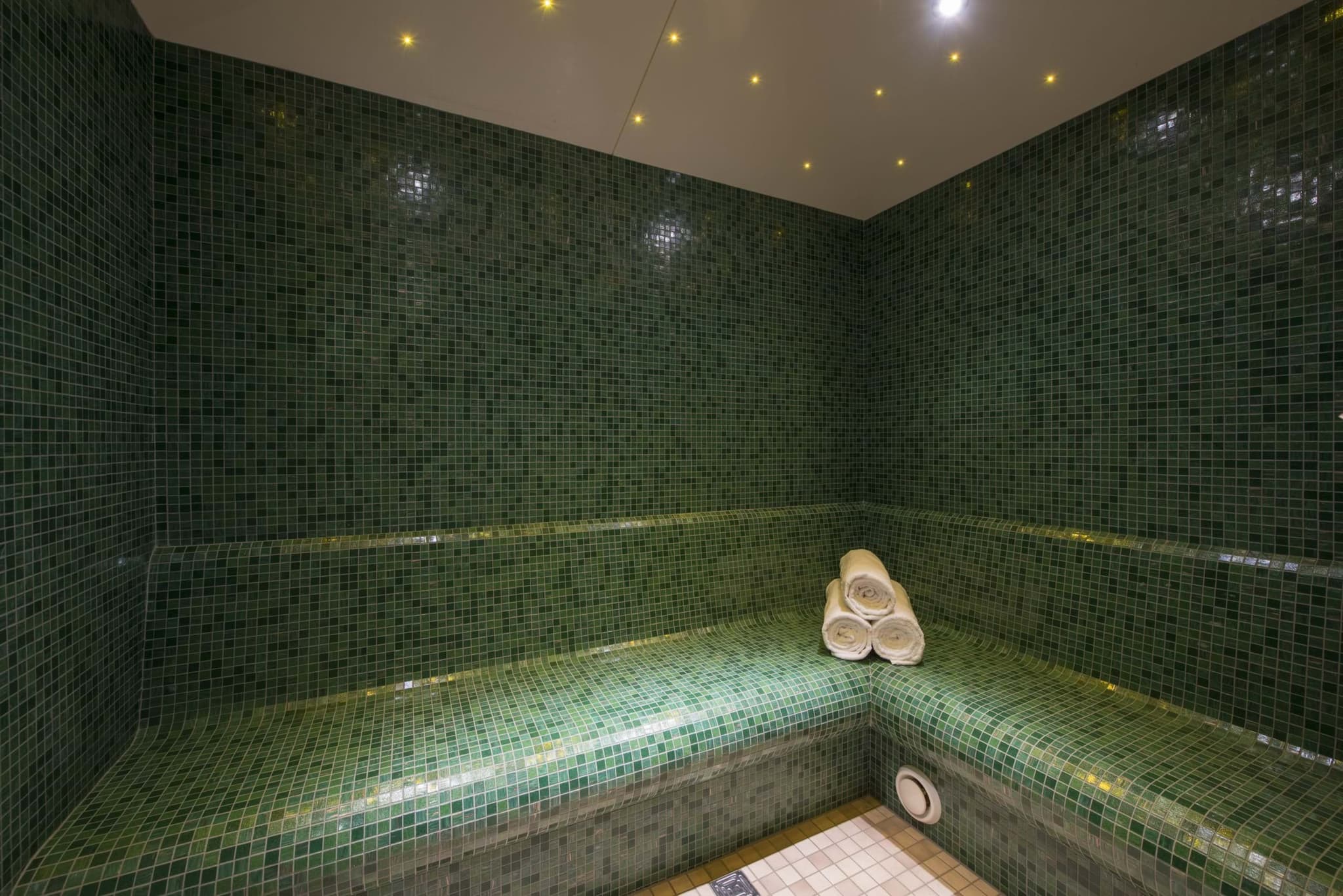 Private steam room with mosaic tiling and starlight ceiling effect