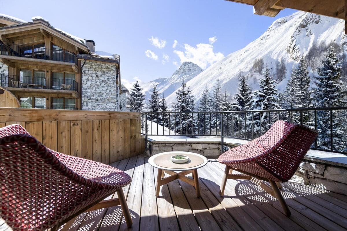 Private balcony with lounge seating for two and mountain views