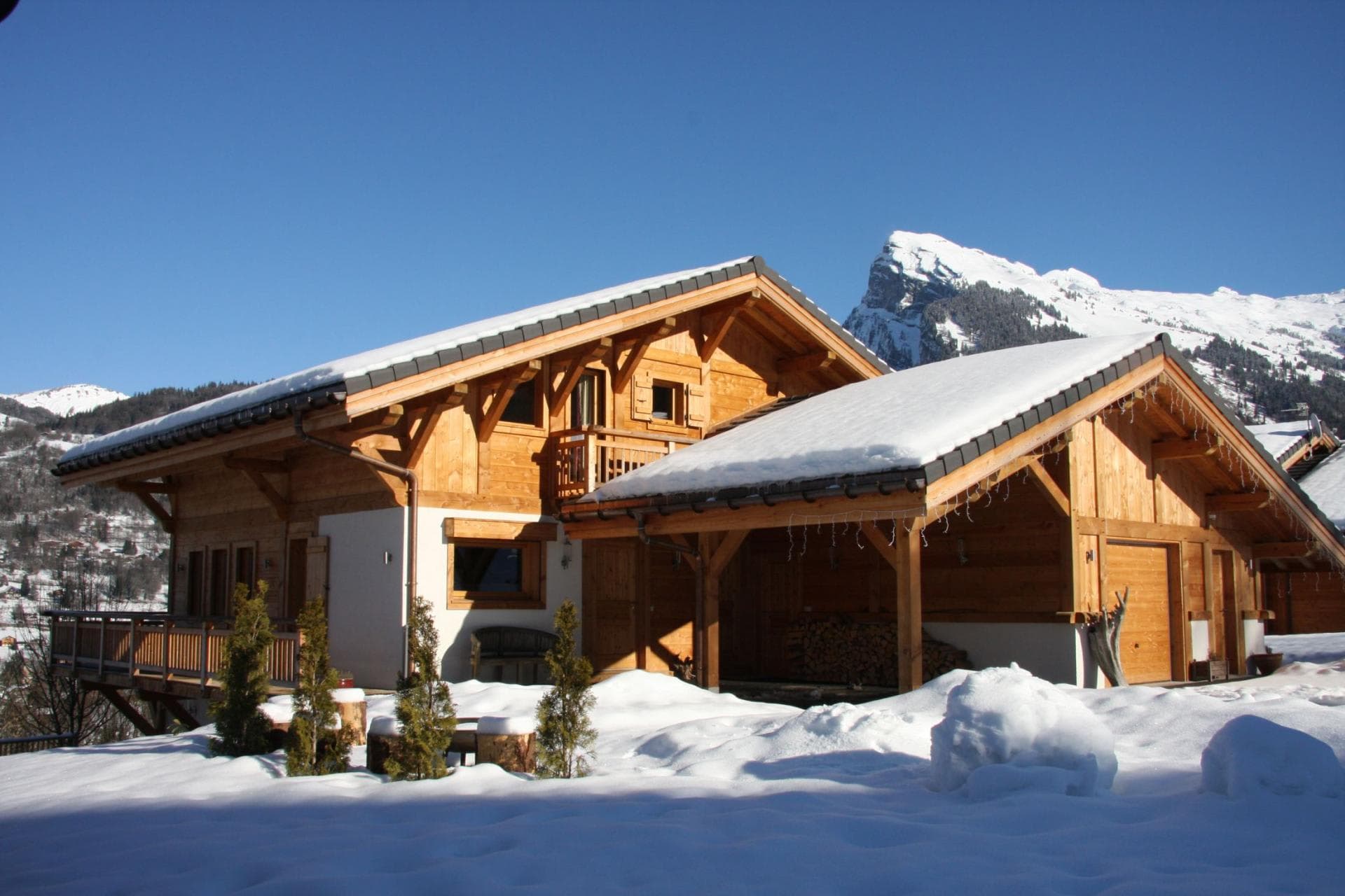Chalet exterior with attached garage and mountain views