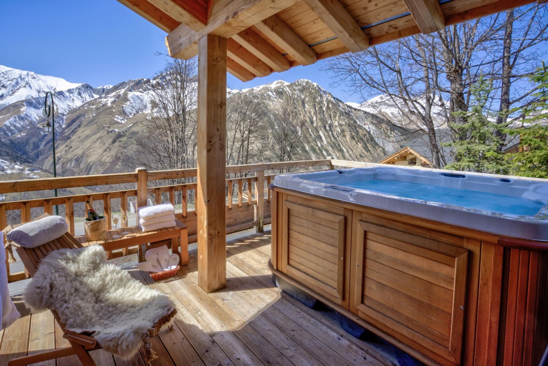 Covered balcony with hot tub and panoramic mountain views
