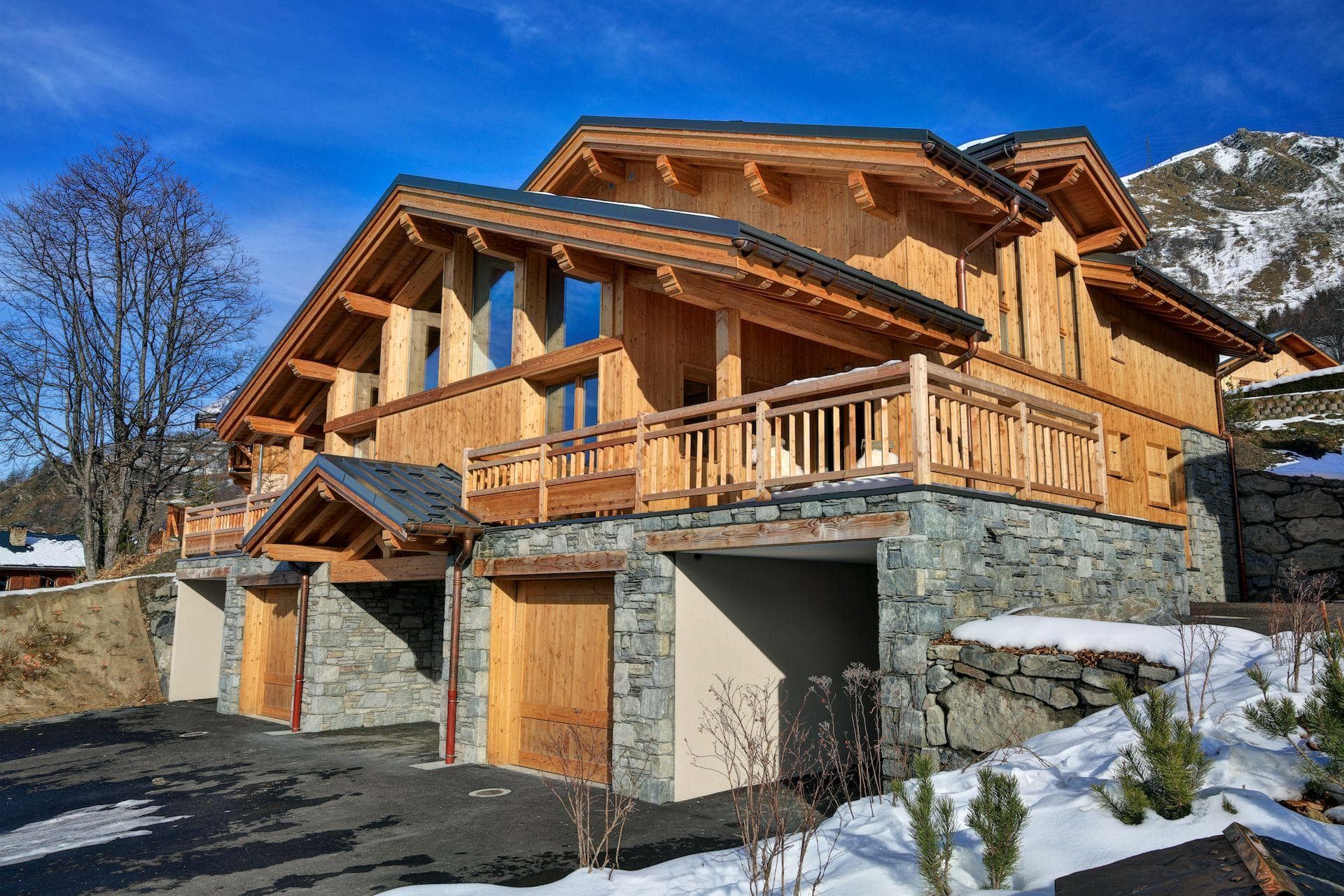 Chalet exterior with three-car garage and wrap-around sun terrace