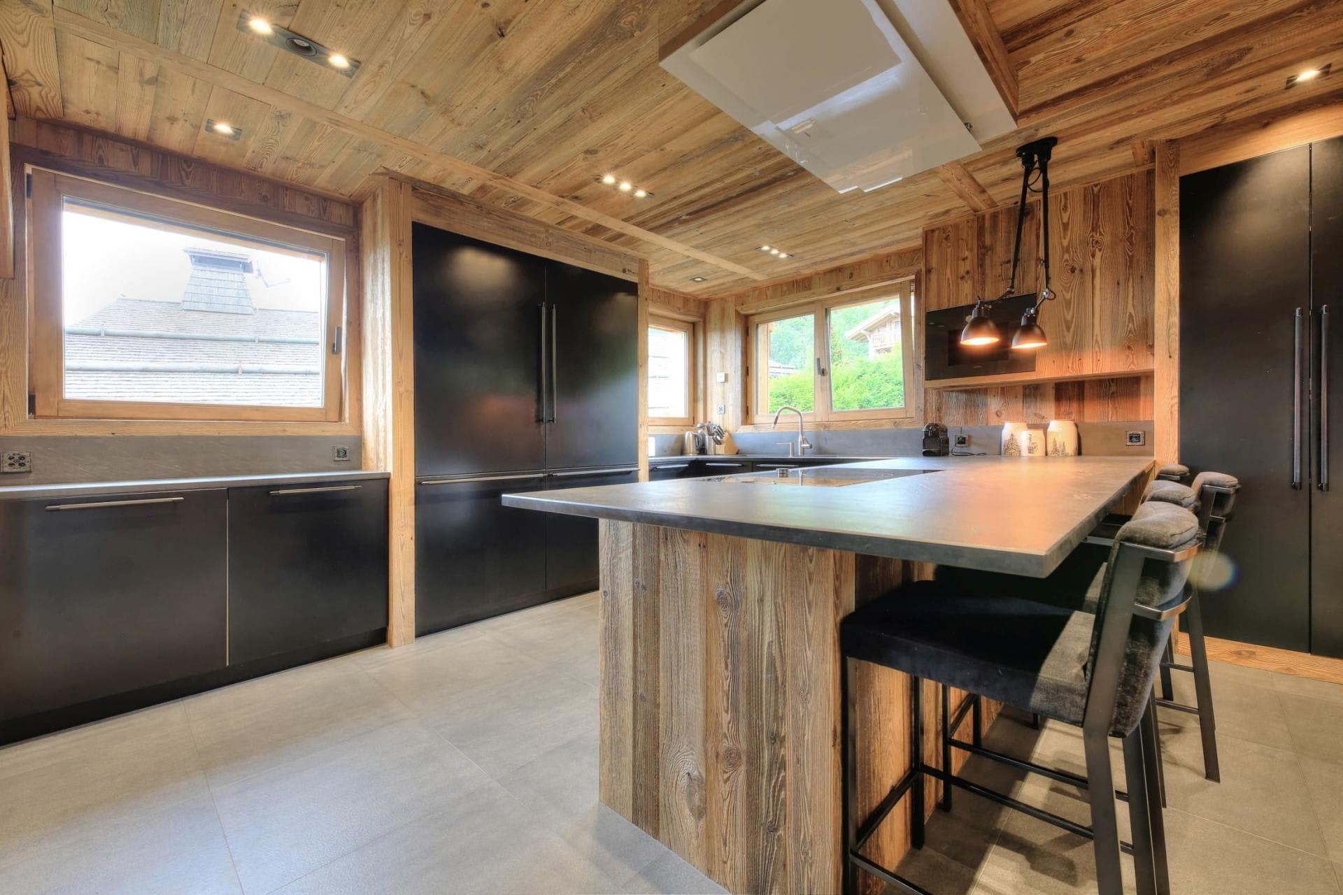 Kitchen with stone countertops and island seating for 4