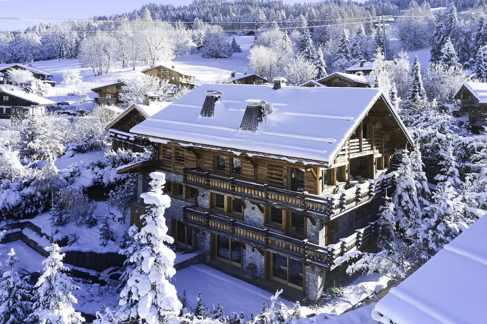 Ski-in chalet with wrap-around balconies and stone-and-timber facade