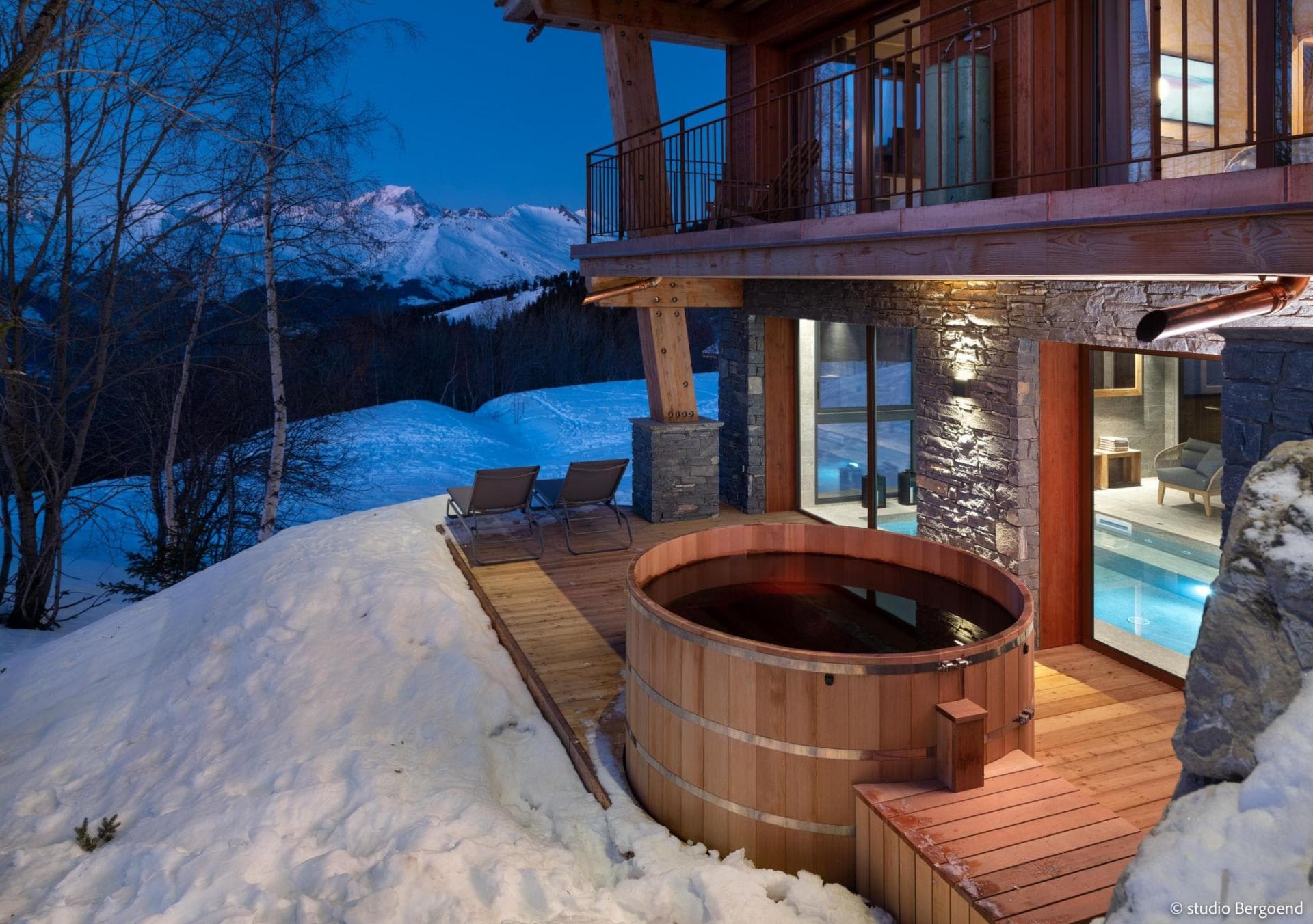 Cedar hot tub with mountain views; adjacent to indoor pool access