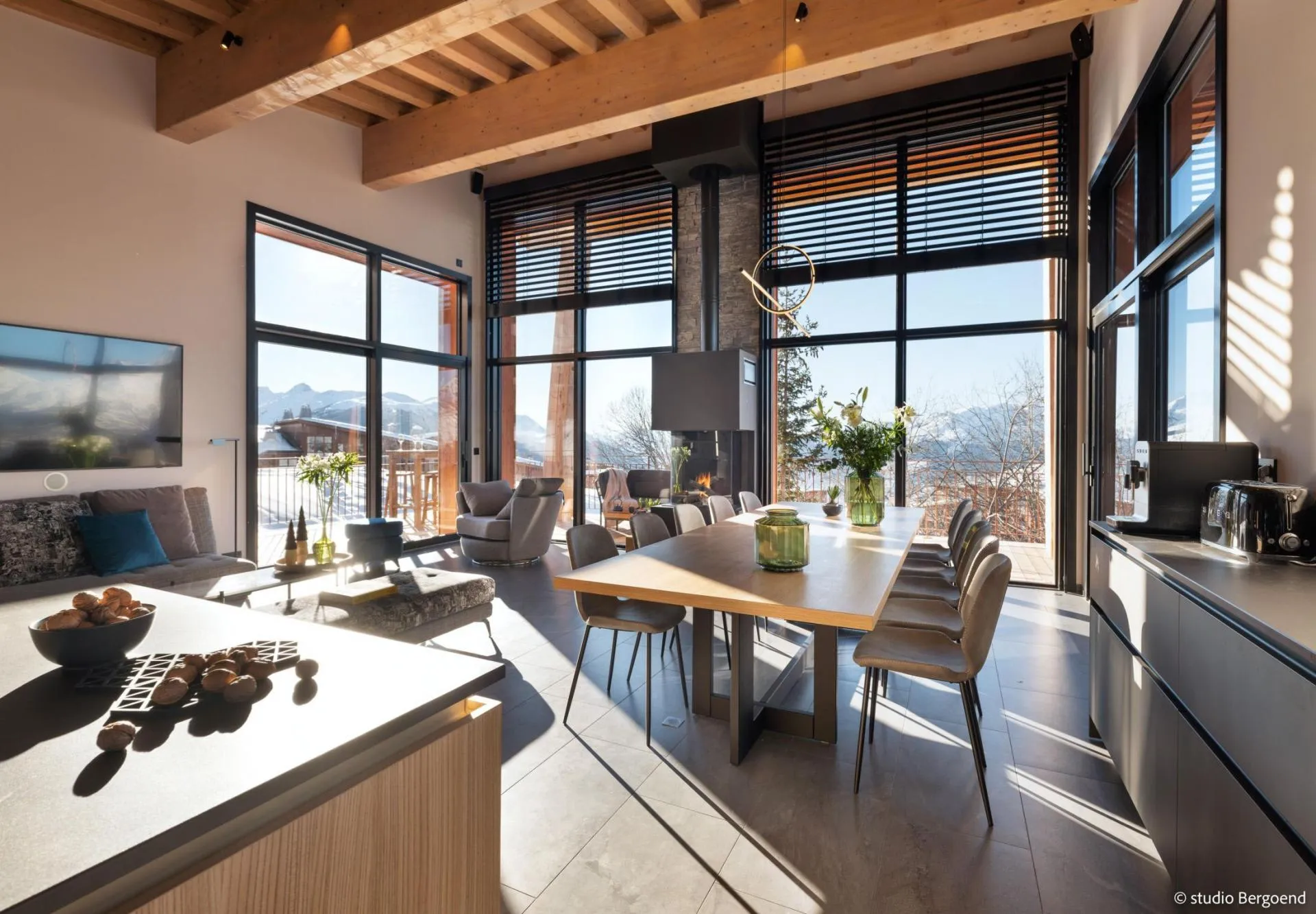 Open-plan dining area beside the gas fireplace and kitchen