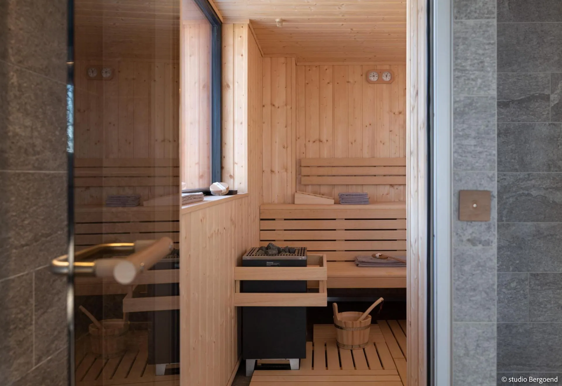 Sauna with tiered timber seating and exterior window