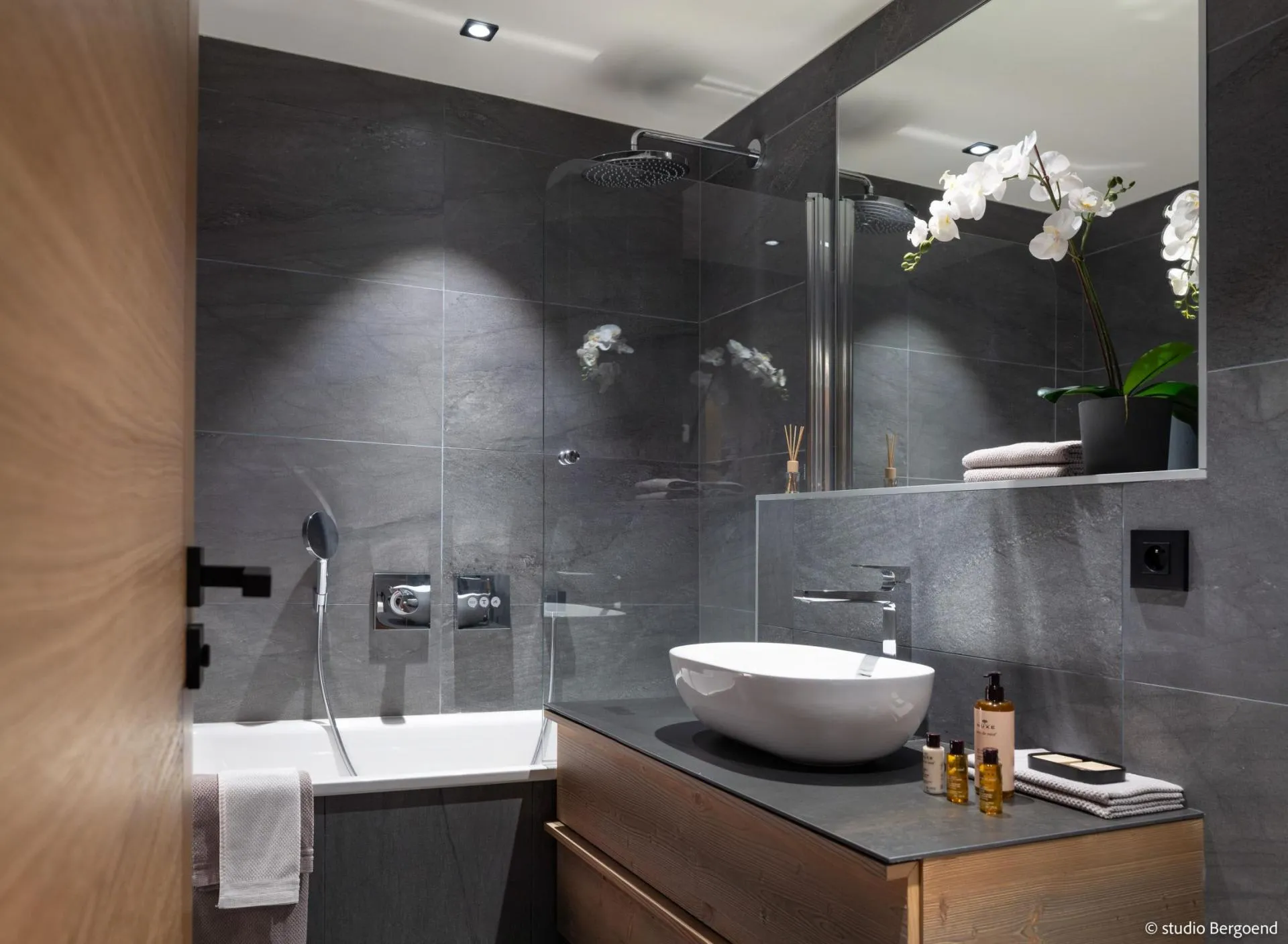 Bathroom with bathtub, walk-in shower and twin vessel basins