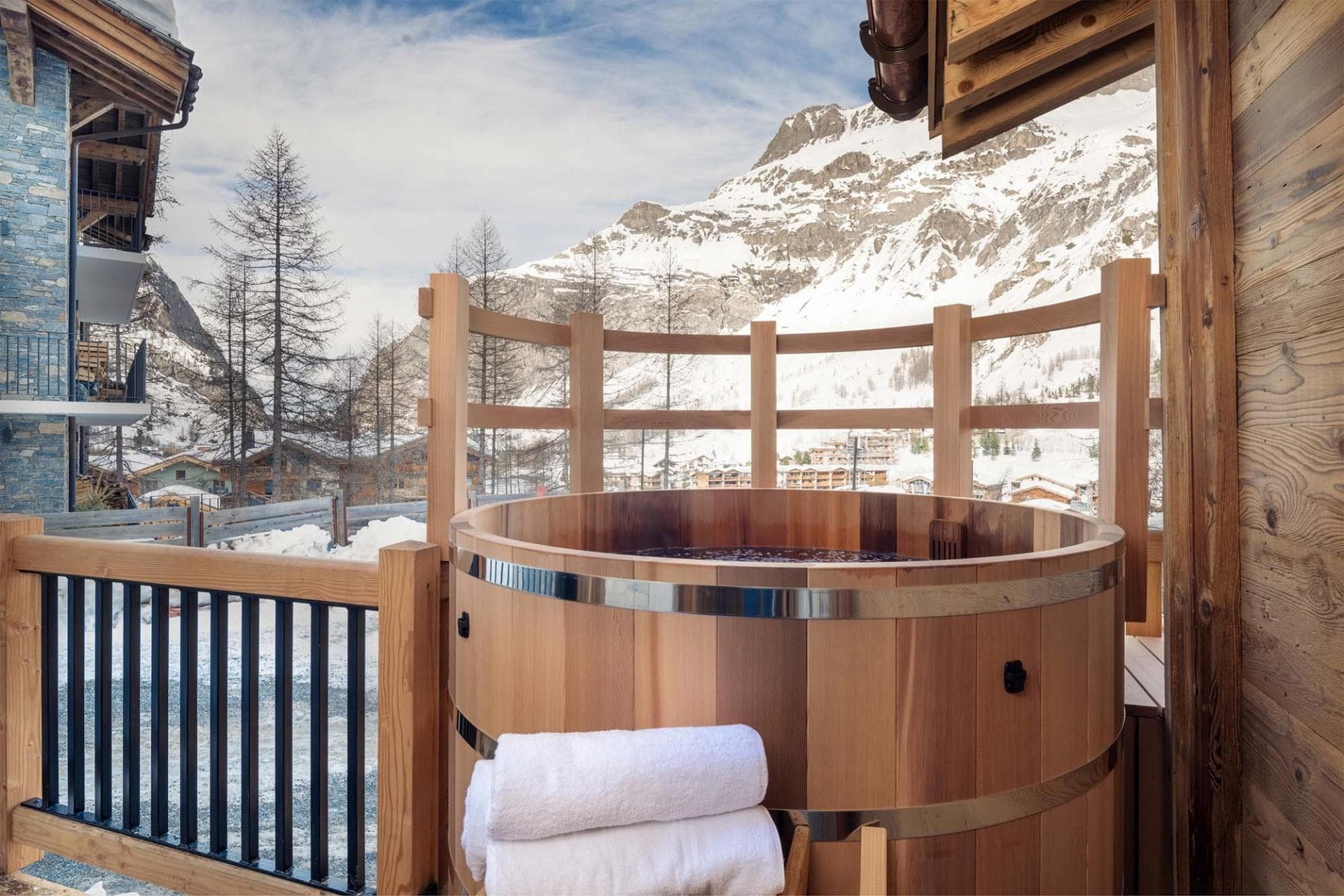 Cedar hot tub on private balcony with mountain and village views