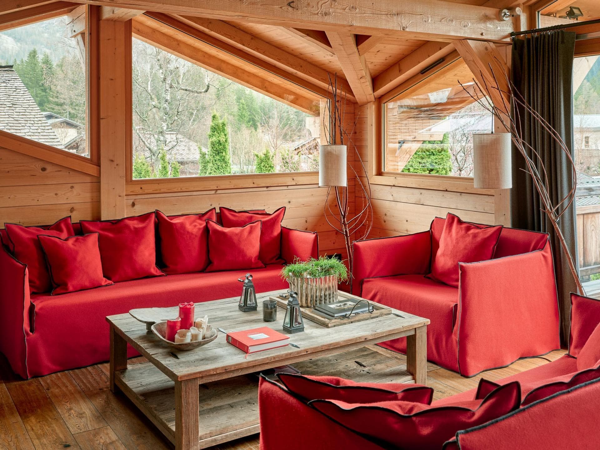 Living area with reclaimed wood coffee table and forest views