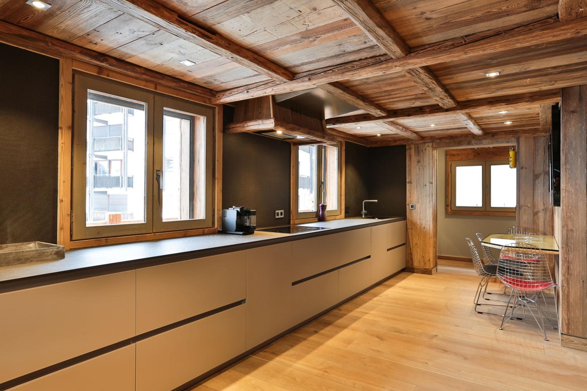 Kitchen with wood-beamed ceiling and integrated induction cooktop