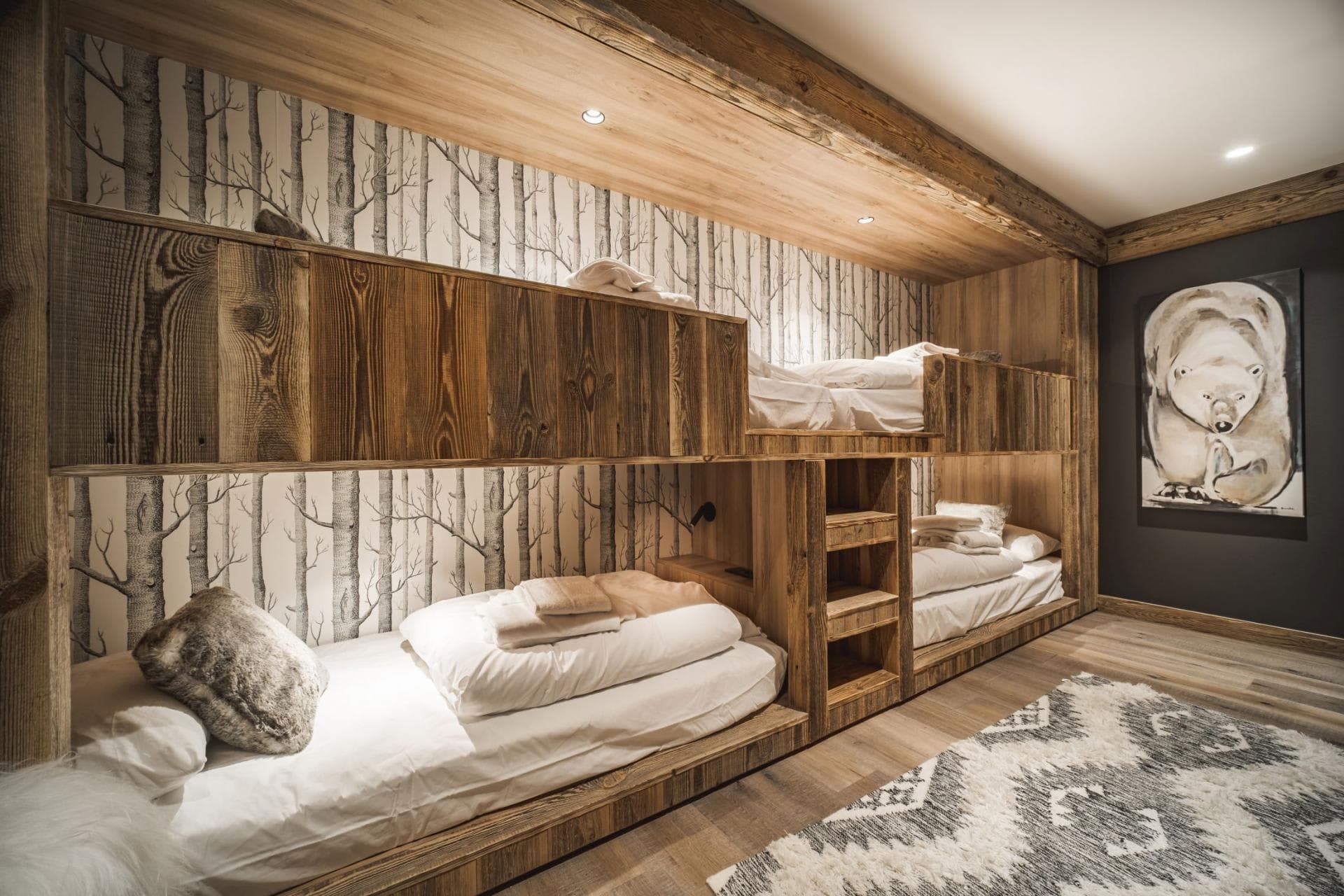 Bunk room with four twin beds and integrated timber shelving