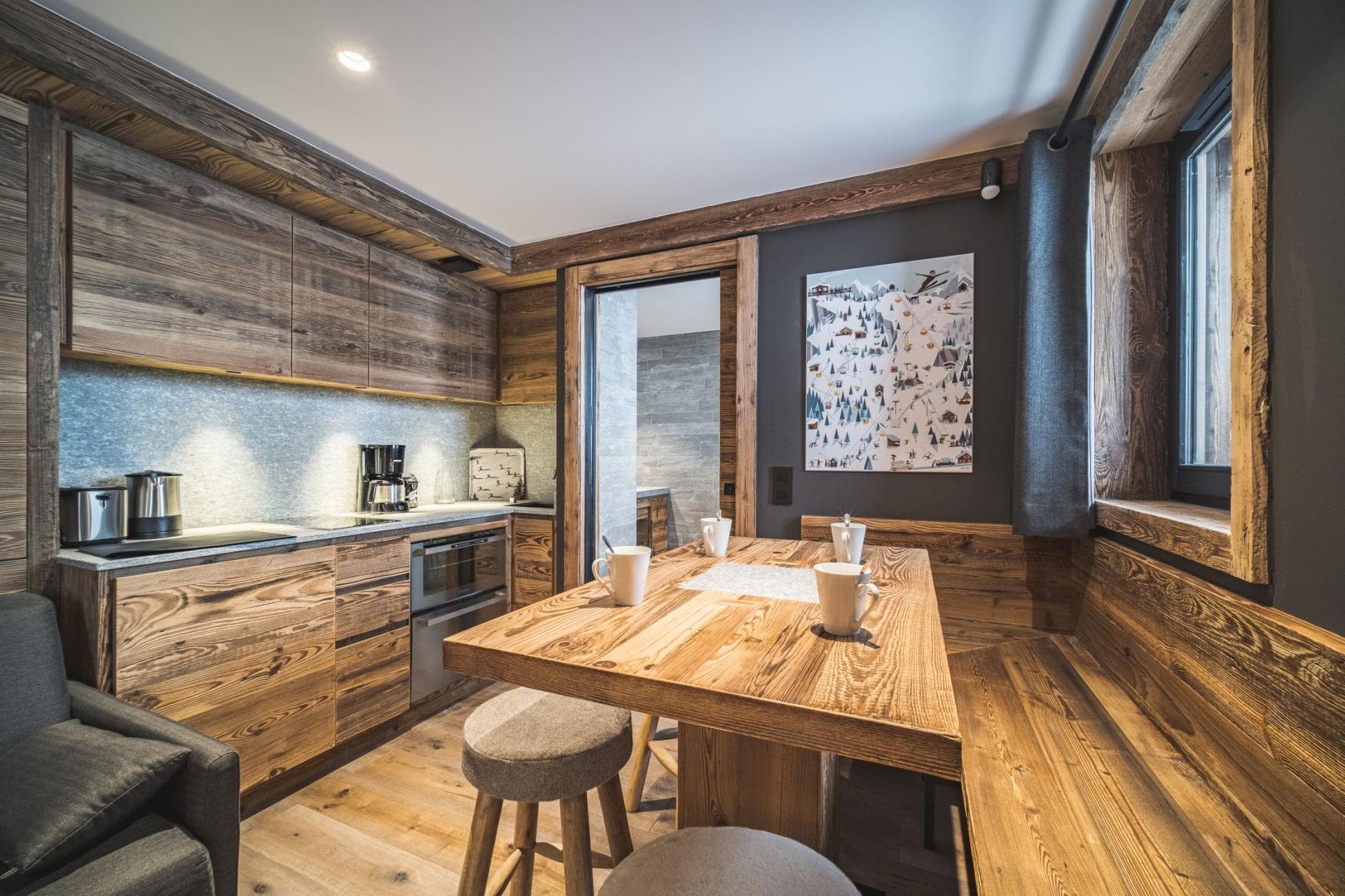 Kitchen and dining area with reclaimed wood cabinetry and built-in bench seating