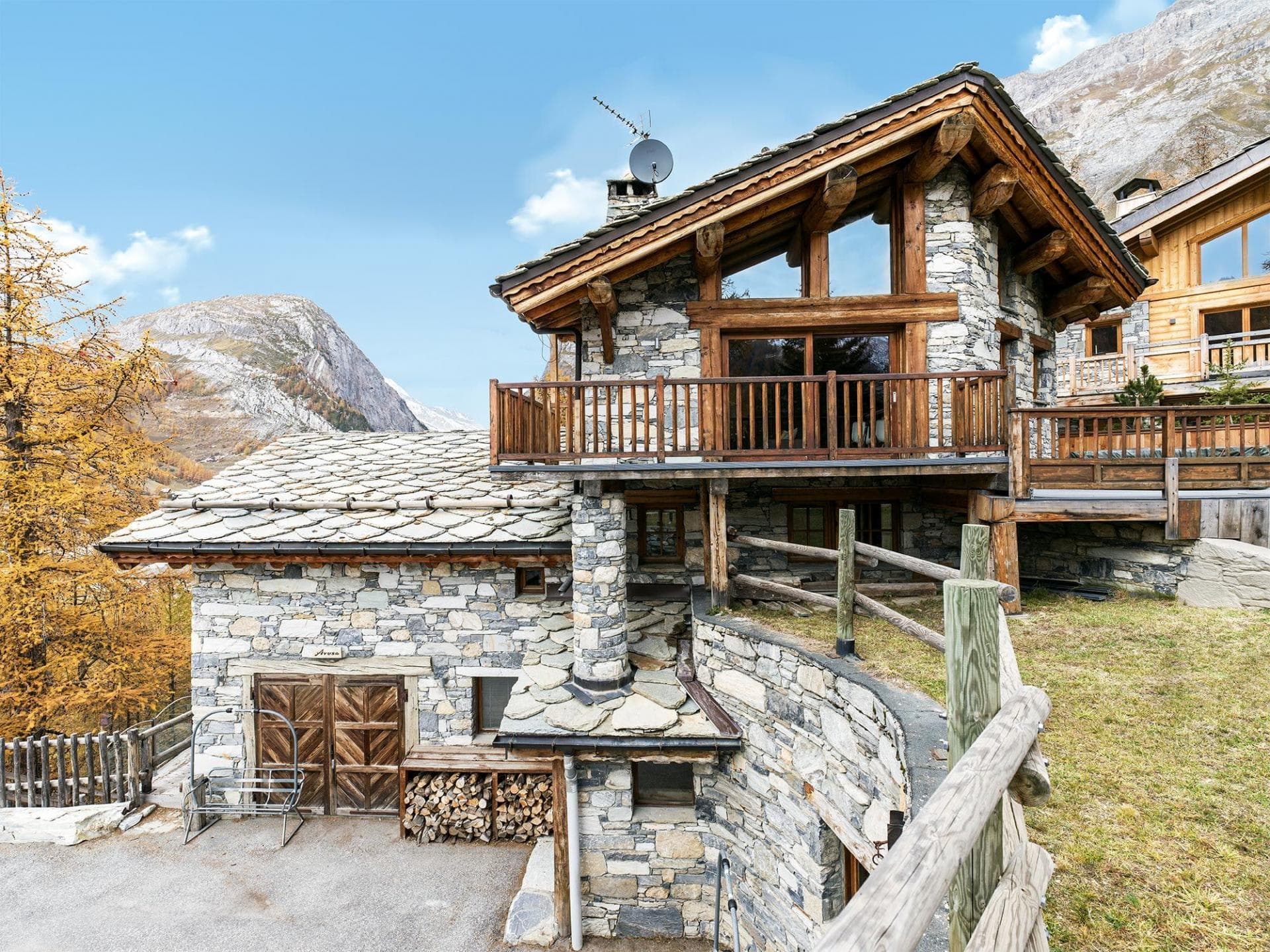 Stone and timber chalet exterior with mountain views and private balcony