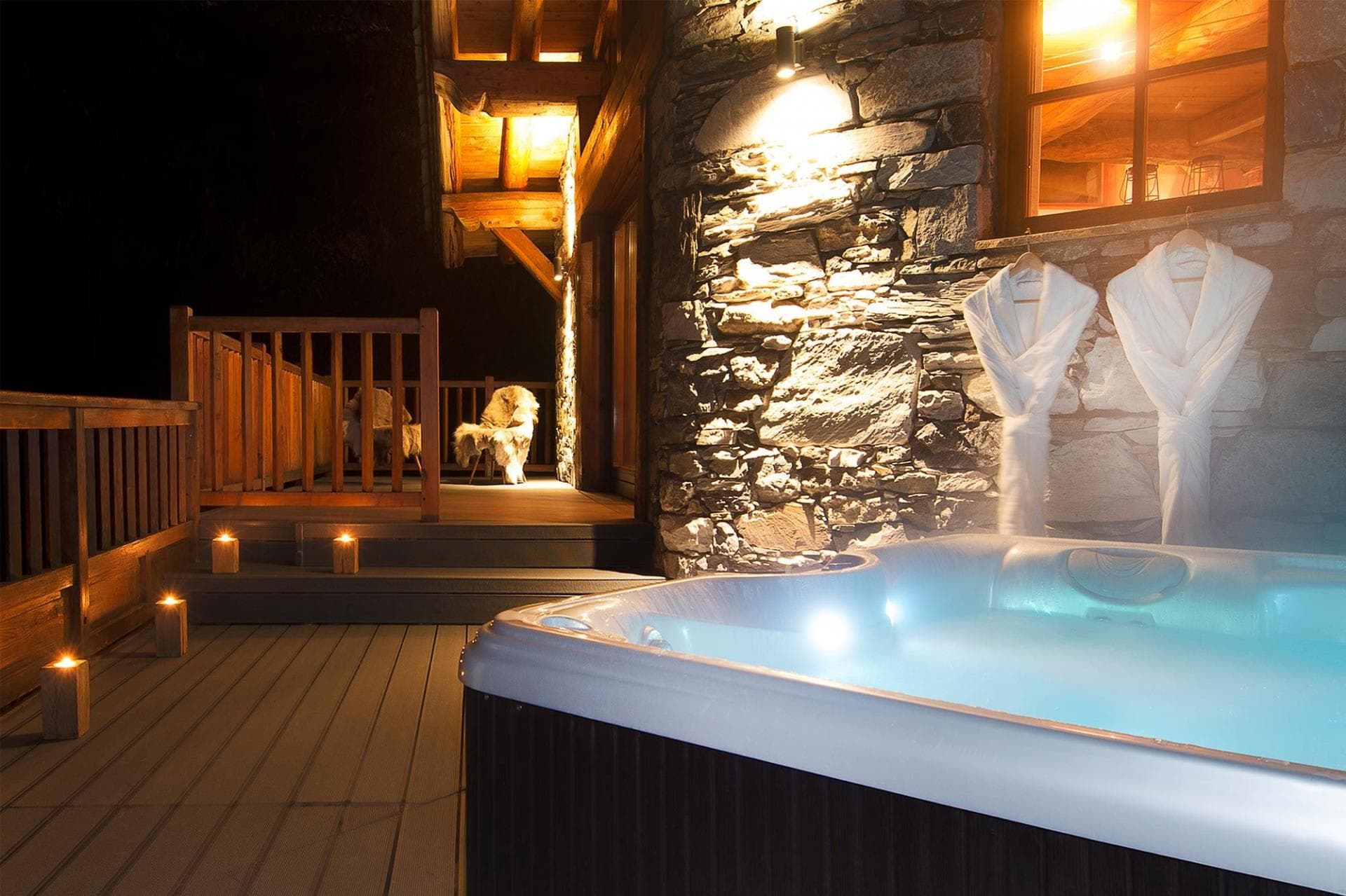 Outdoor hot tub on private deck with complimentary robes