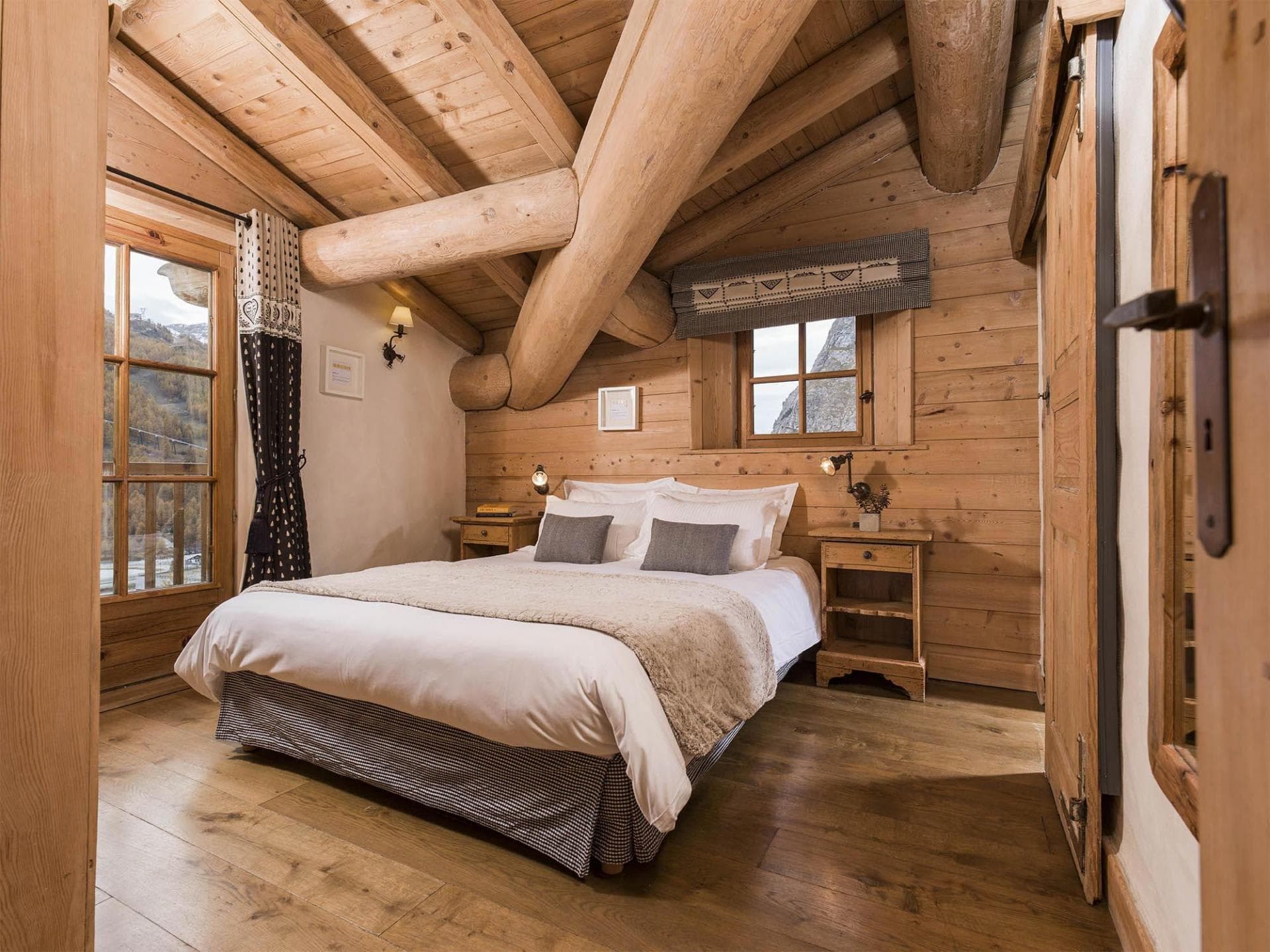 Loft bedroom with queen bed and exposed log beams