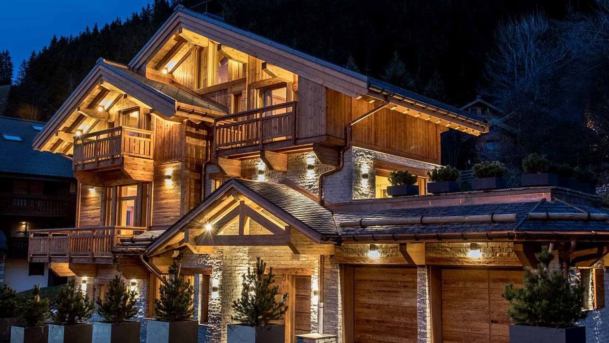 Chalet exterior with two-car heated garage and multiple private balconies